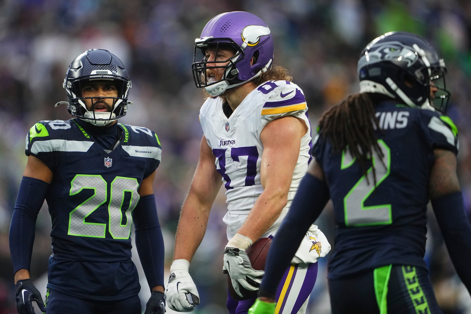 Minnesota Vikings tight end T.J. Hockenson (87) celebrates after catching a pass against Seattle Seahawks safeties Julian Love (20) Rayshawn Jenkins (2) during the second half of an NFL football game, Sunday, Dec. 22, 2024, in Seattle. (AP Photo/Lindsey Wasson)