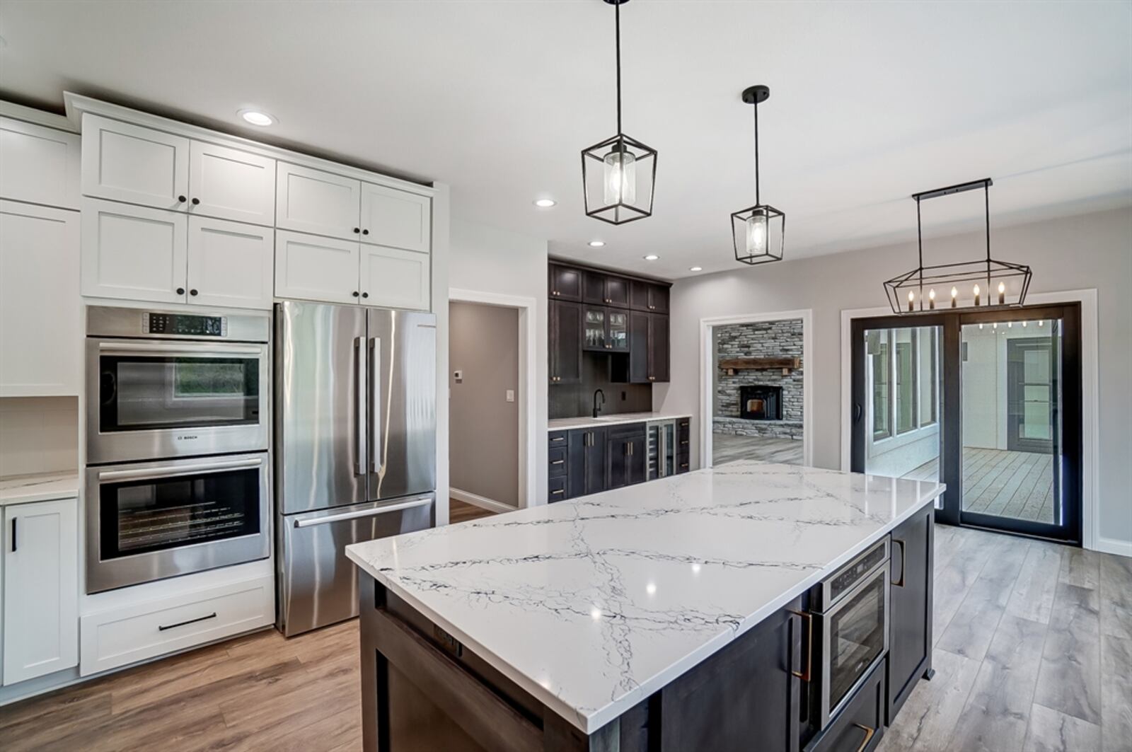 The kitchen has been redesigned with a spacious island and wet bar area. 