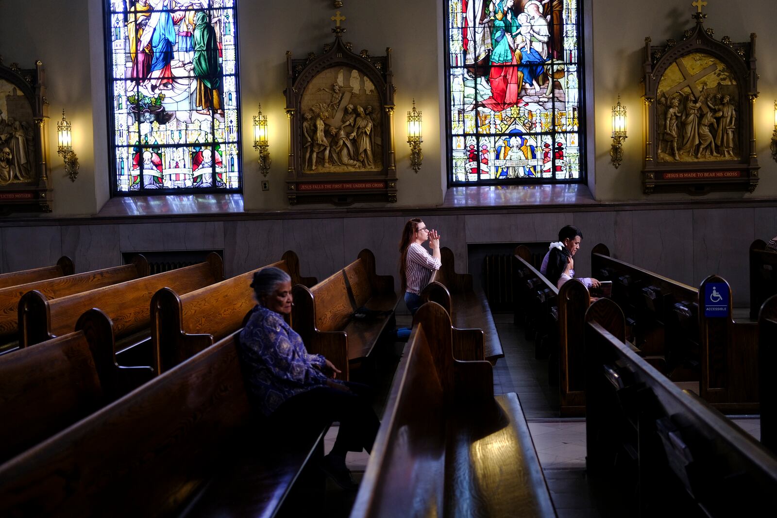 FILE - A parishioner prays at St. Peter the Apostle Catholic Church in Reading, Pa., June 16, 2024. (AP Photo/Luis Andres Henao, File)