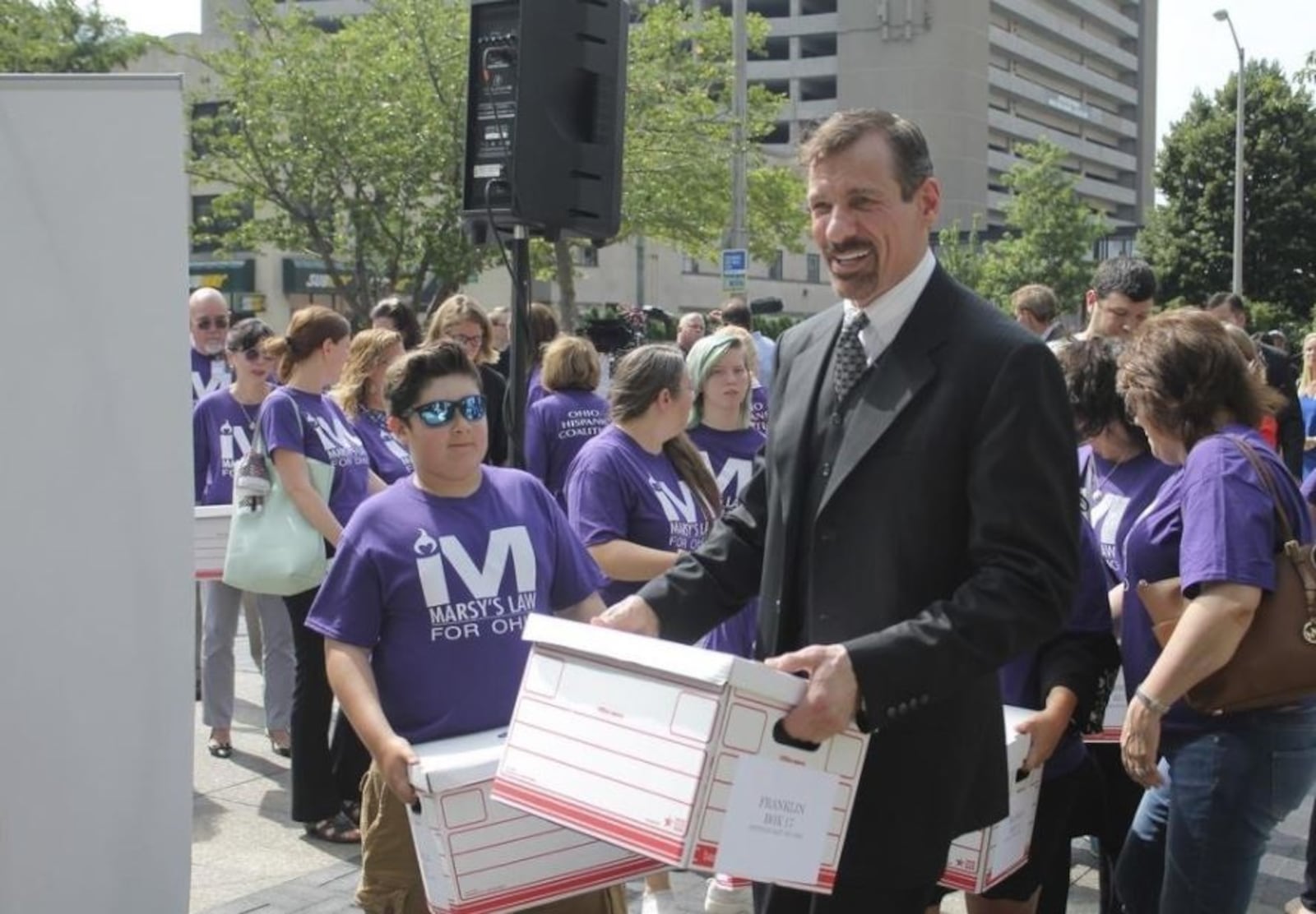 Marsy’s Law founder Henry Nicholas and other supporters of the victims right constitutional amendment help carry boxes of petitions into the secretary of state’s office. Voters easily approved the measure Tuesday. MARC KOVAC/ GATEHOUSE MEDIA