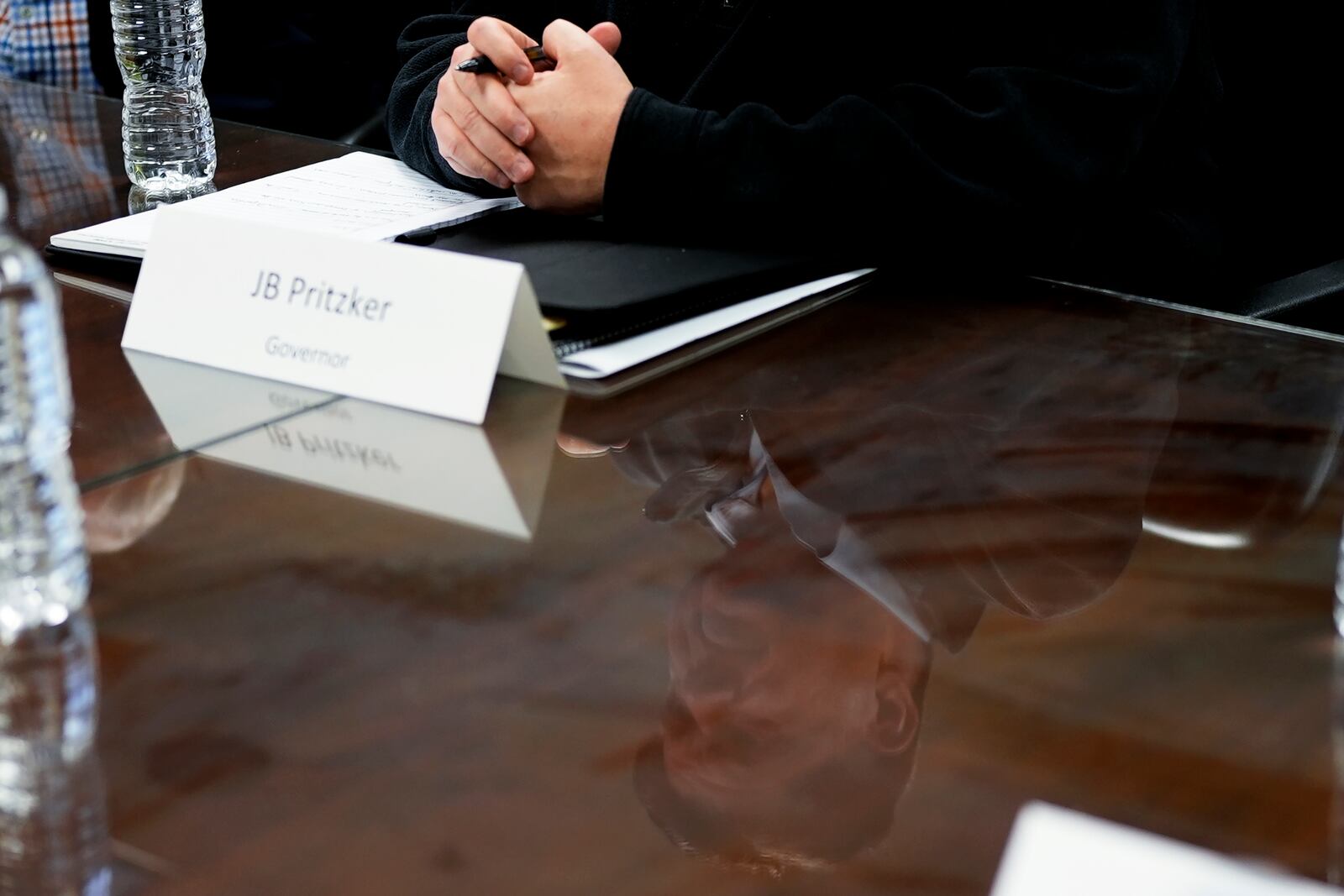 Illinois Gov. JB Pritzker is pictured in reflection during a visit to the Soybean Innovation Lab at the University of Illinois, which is impacted by DOGE funding cuts, in Urbana, Ill., Wednesday, March 19, 2025. (AP Photo/Nam Y. Huh)