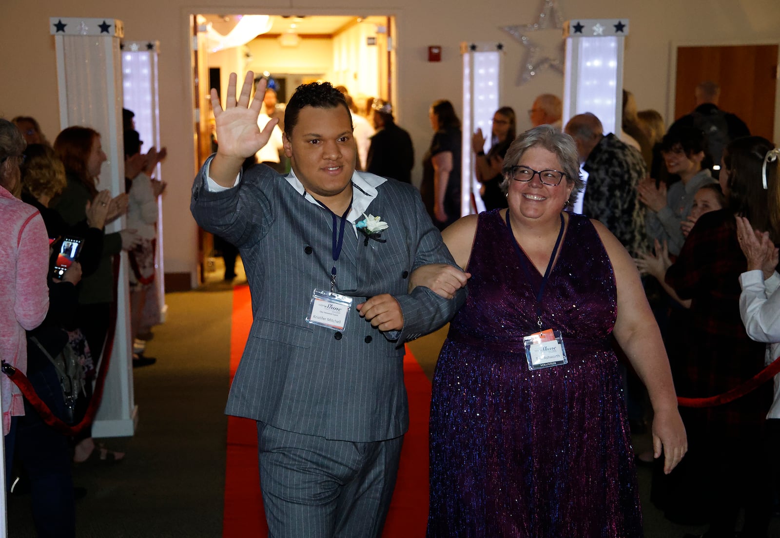 Kristifer Mitchell arrives on the red carpet at the Night to Shine prom for individuals with special needs was held at the Lawrenceville Church of God Friday, Feb. 9, 2024. Night to Shine is for anyone over age 14 with special needs and is hosted by churches around the world.  This year's event included  a red carpet entrance, limousine rides, dancing, karaoke, gifts, a catered dinner and a respite room for parents and caregivers. BILL LACKEY/STAFF