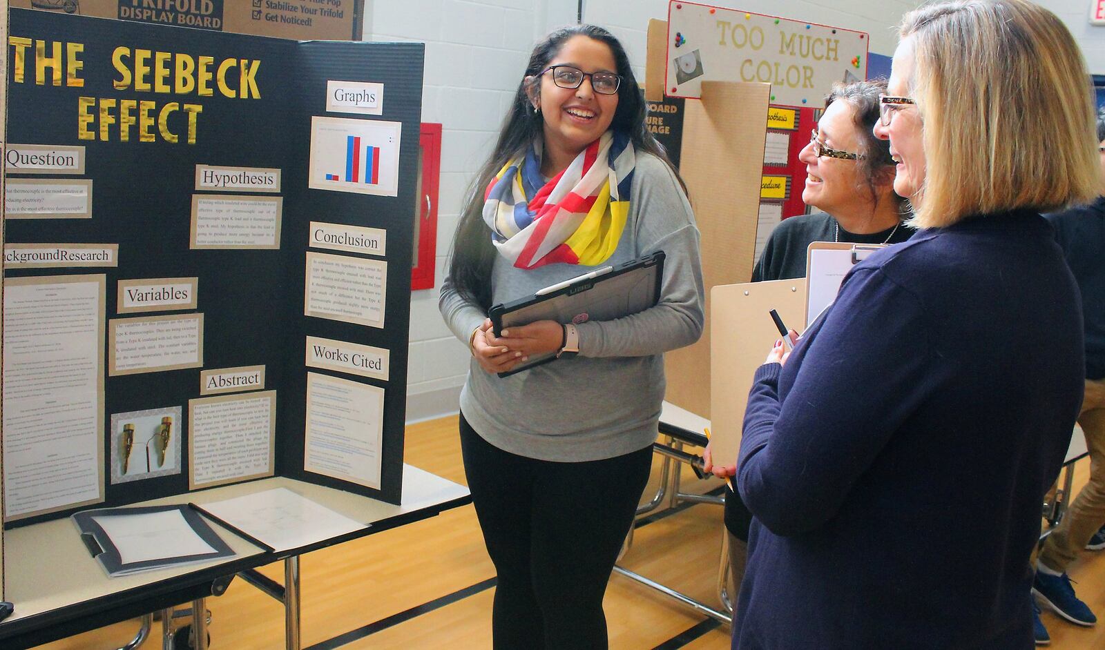 Ridgewood School eight grade student (left) Khushi Patel explains her science project to judges Gail Suzel and Karen Blevins. JEFF GUERINI/STAFF