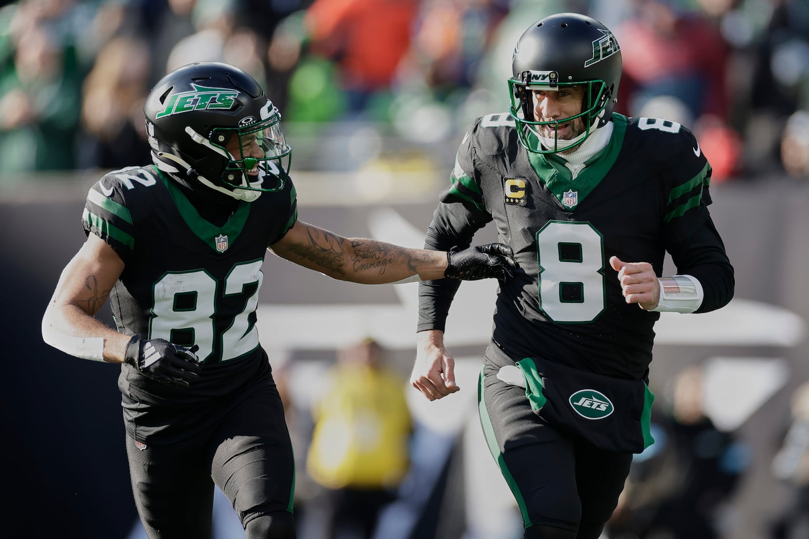 New York Jets wide receiver Xavier Gipson (82) and quarterback Aaron Rodgers (8) celebrate after a Jet touchdown against the Seattle Seahawks during the first quarter of an NFL football game, Sunday, Dec. 1, 2024, in East Rutherford, N.J. (AP Photo/Adam Hunger)