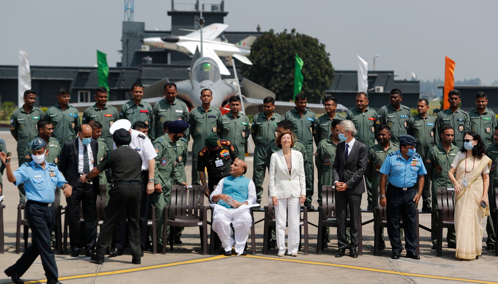 Indian Defense Minister Rajnath Singh, center left and French Defense Minister Florence Parly, center right, pose for a group photo with Rafale squadron during an induction ceremony of French-made Rafale fighter jets at Air Force Station Ambala, India, Thursday, Sept.10, 2020. The first batch of five planes, part of a $8.78 billion deal signed between the two countries in 2016 had arrived here in July. (AP Photo/Manish Swarup)