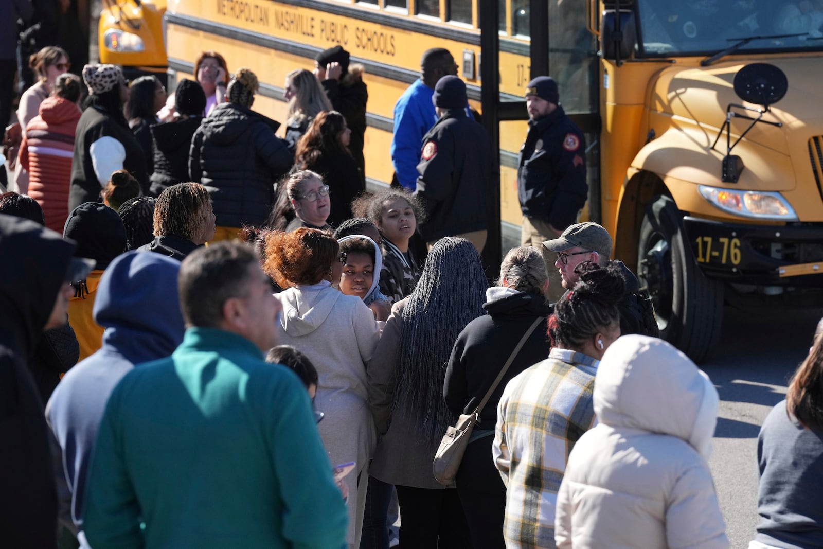 School buses arrive at a unification site following a shooting at the Antioch High School in Nashville, Tenn., Wednesday, Jan. 22, 2025. (AP Photo/George Walker IV)