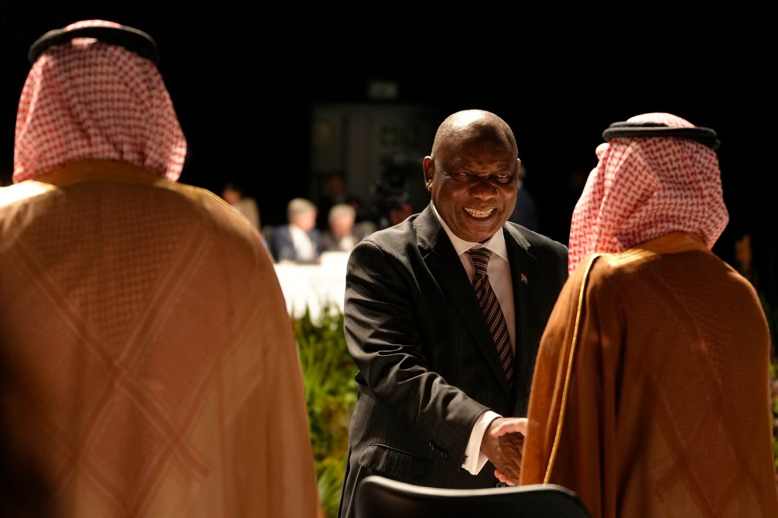 South Africa's President Cyril Ramaphosa, center, greets delegates at G20 Finance Ministers and Central Bank Governors meeting in Cape Town, South Africa, Wednesday, Feb. 26, 2025. (AP Photo/Nardus Engelbrecht)