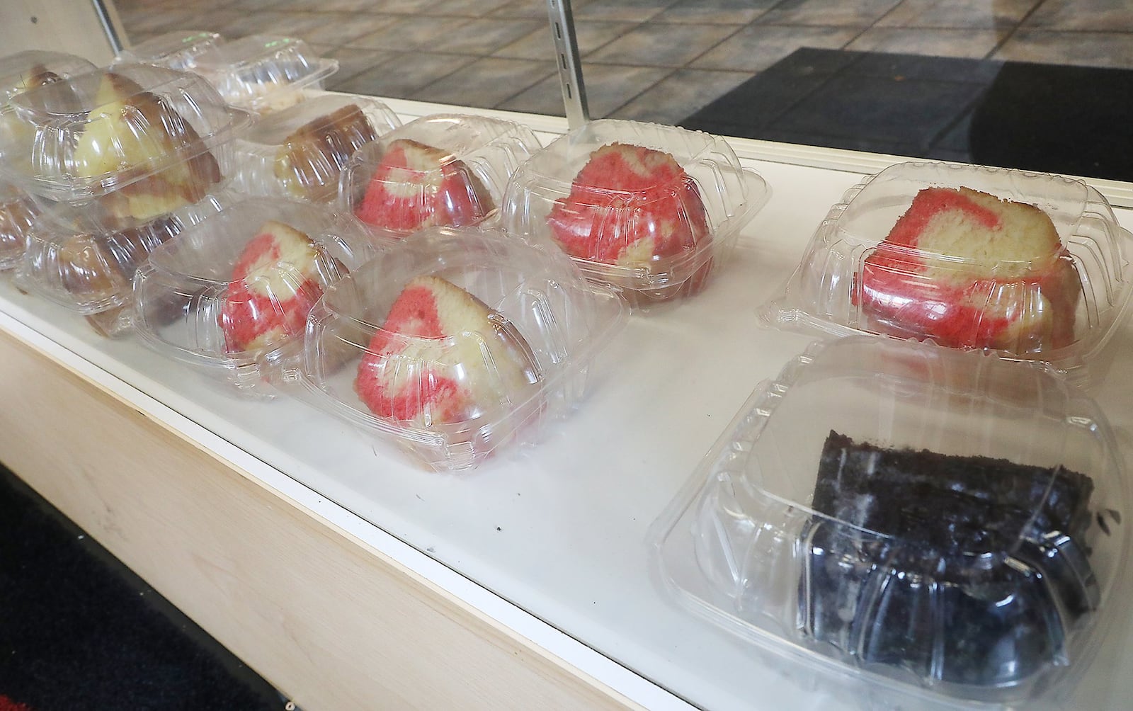 A variety of cakes in the desert case at Al’s Smokehouse Carryout & Catering. BILL LACKEY/STAFF