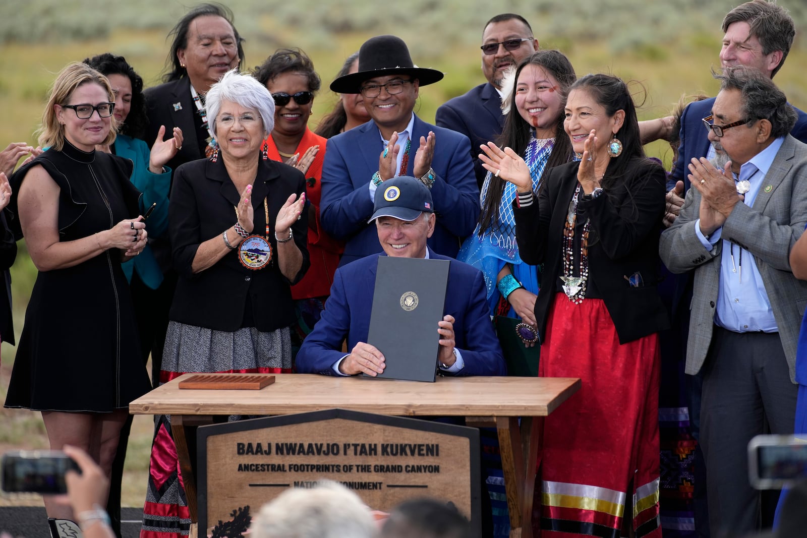 FILE - President Joe Biden holds up a proclamation designating the Baaj Nwaavjo I'Tah Kukveni National Monument at the Red Butte Airfield on Aug. 8, 2023, in Tusayan, Ariz. (AP Photo/John Locher, File)