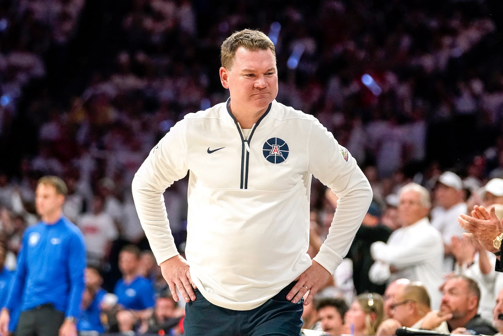 Arizona Wildcats coach Tommy Lloyd reacts to a call against his team during the second half of an NCAA college basketball game against Duke Friday, Nov. 22, 2024, in Tucson, Ariz. (AP Photo/Darryl Webb)