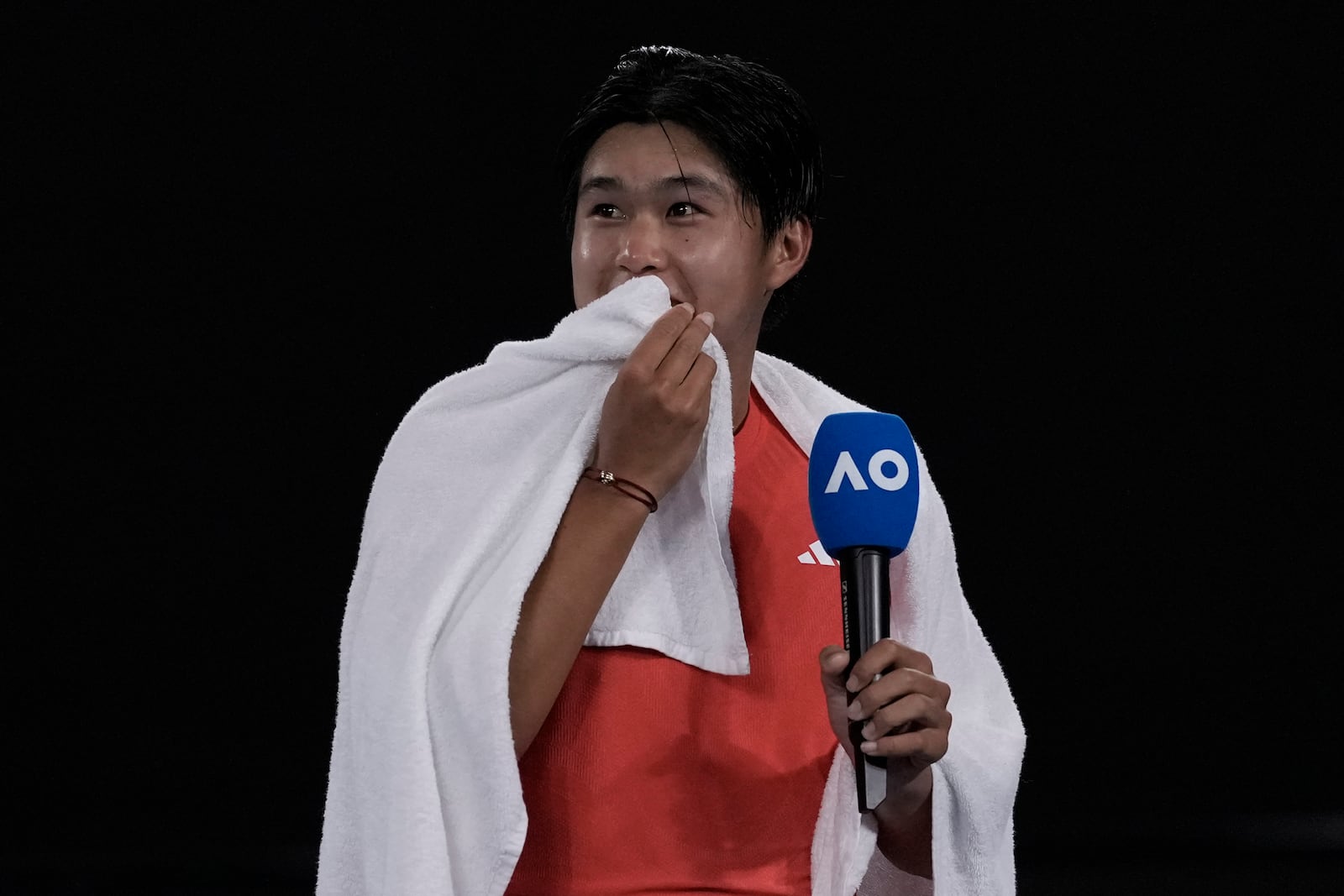 Learner Tien of the U.S. speaks after winning his second round match against Daniil Medvedev of Russia at the Australian Open tennis championship in Melbourne, Australia, in the early hours of Friday, Jan. 17, 2025. (AP Photo/Ng Han Guan)