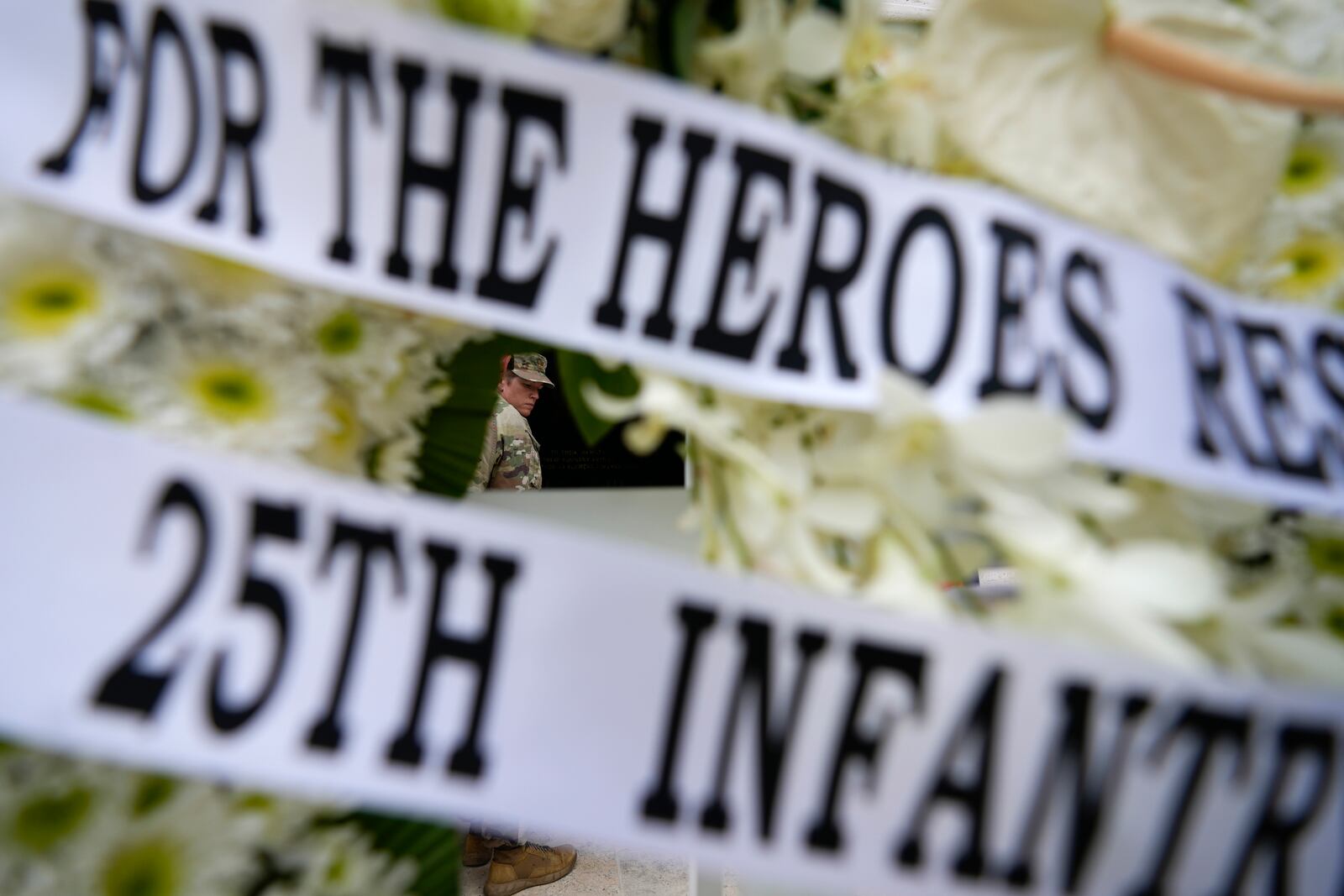 An American soldier walks past a wreath during ceremonies to honor American soldiers died during World War II at the Manila American Cemetery and Memorial in Taguig, Philippines Monday, Oct. 21, 2024. (AP Photo/Aaron Favila)