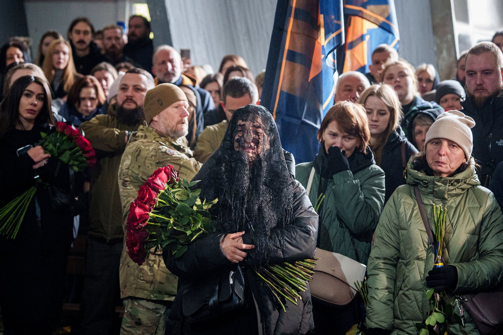 A woman cries near the coffin of Valentyna Nagorna aka "Valkiria", Ukrainian military medic of 3rd assault brigade, who was killed together with his boyfriend Danylo Liashkevych aka "Berserk, during the funeral ceremony at crematorium in Kyiv, Ukraine, Friday, Nov. 8, 2024. (AP Photo/Evgeniy Maloletka)