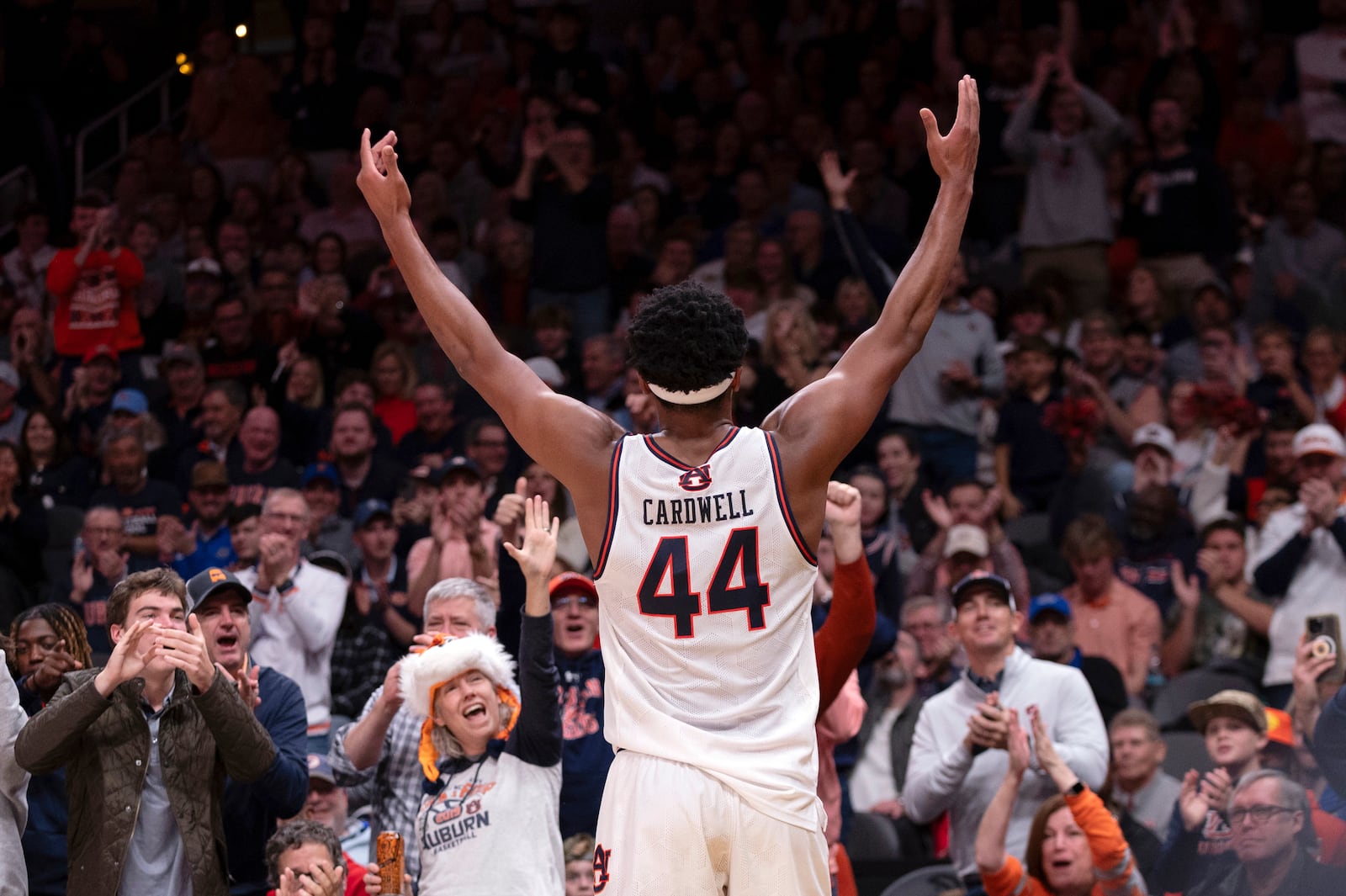 Auburn center Dylan Cardwell (44) celebrates towards the crowd during the second half of an NCAA college basketball game against Ohio State, Saturday, Dec. 14, 2024, in Atlanta. (AP Photo/Kathryn Skeean)