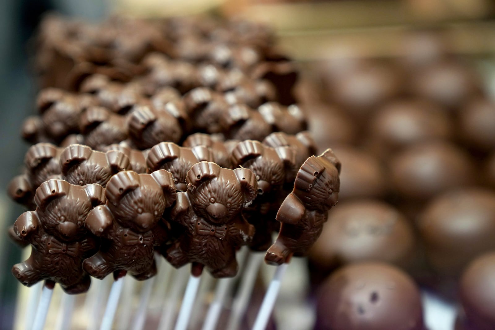 Chocolate lollypops are displayed in a glass sales case at The Chocolate Line in Bruges, Belgium, Thursday, Feb. 6, 2025. (AP Photo/Virginia Mayo)