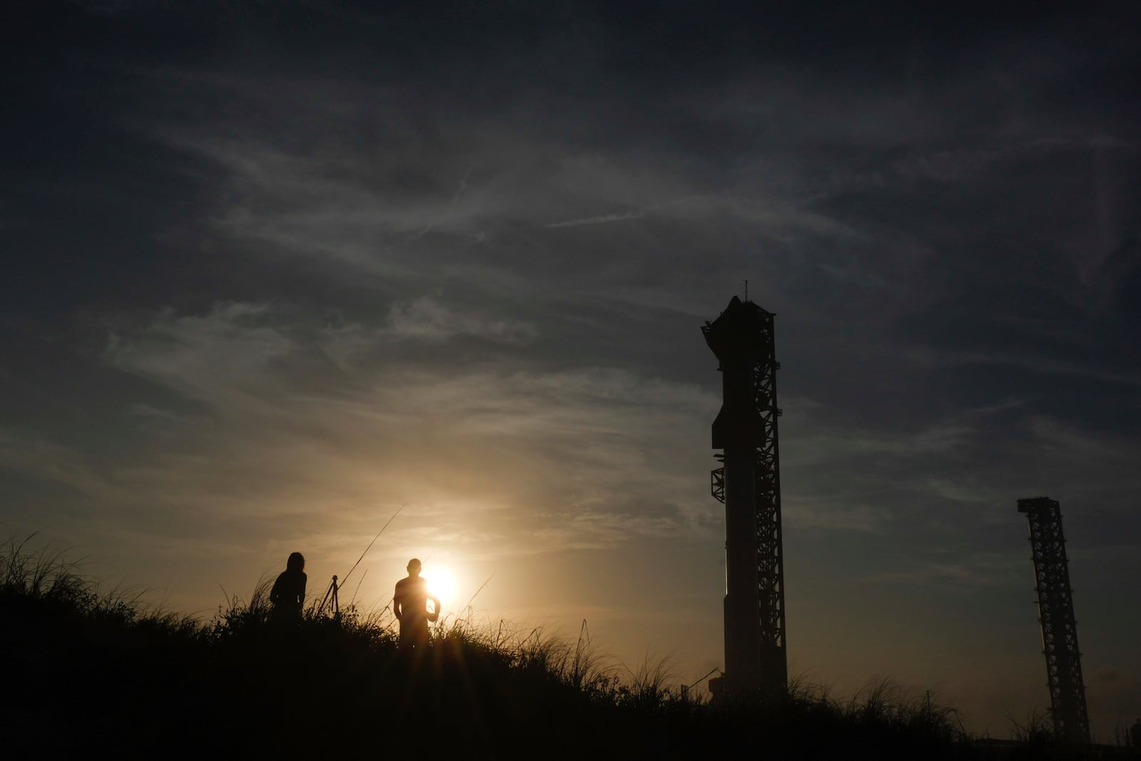 FILE - The sun sets behind SpaceX's mega rocket Starship as it is prepares for a test flight from Starbase in Boca Chica, Texas, Nov. 18, 2024. (AP Photo/Eric Gay, File)