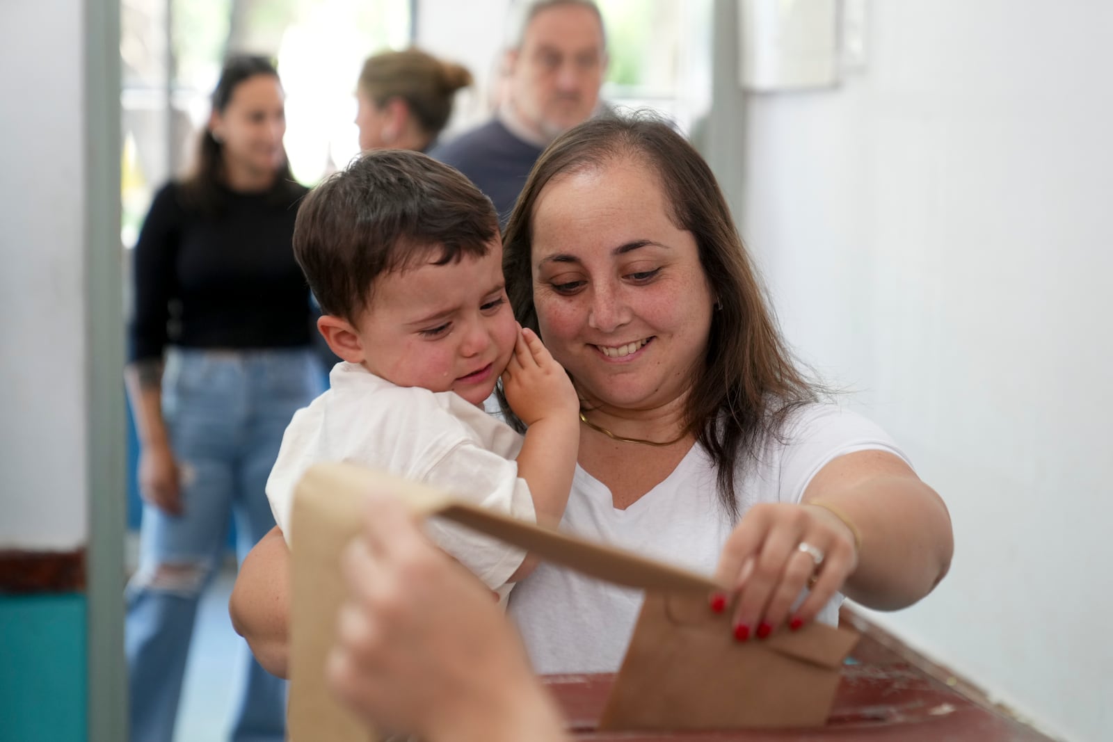 A woman votes during general elections in Canelones, Uruguay, Sunday, Oct. 27, 2024. (AP Photo/Matilde Campodonico)