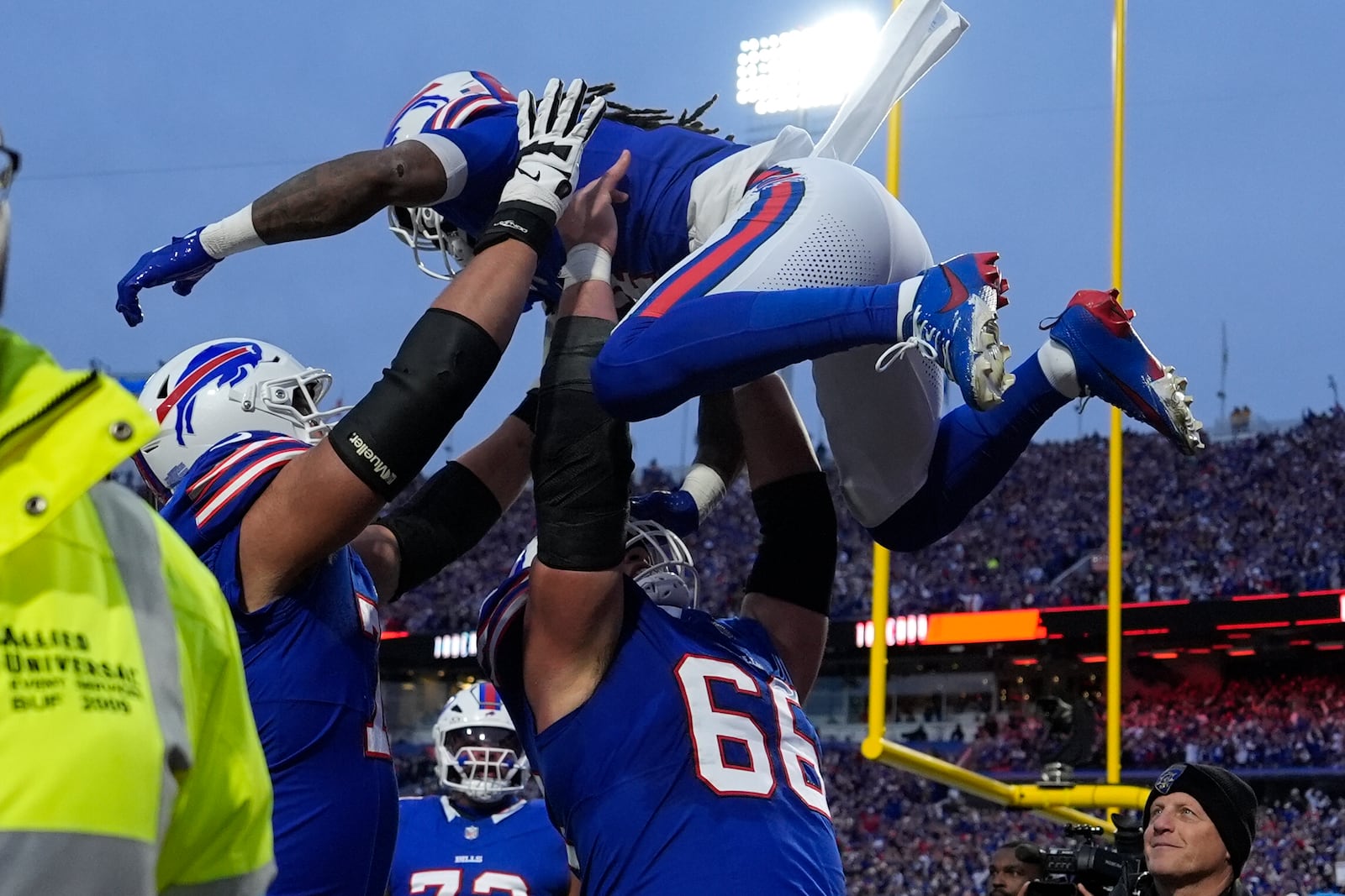 Buffalo Bills running back James Cook is lifted by teammate Connor McGovern (66) after scoring during the first half of an NFL football game against the Kansas City Chiefs Sunday, Nov. 17, 2024, in Orchard Park, N.Y. (AP Photo/Julia Demaree Nikhinson)