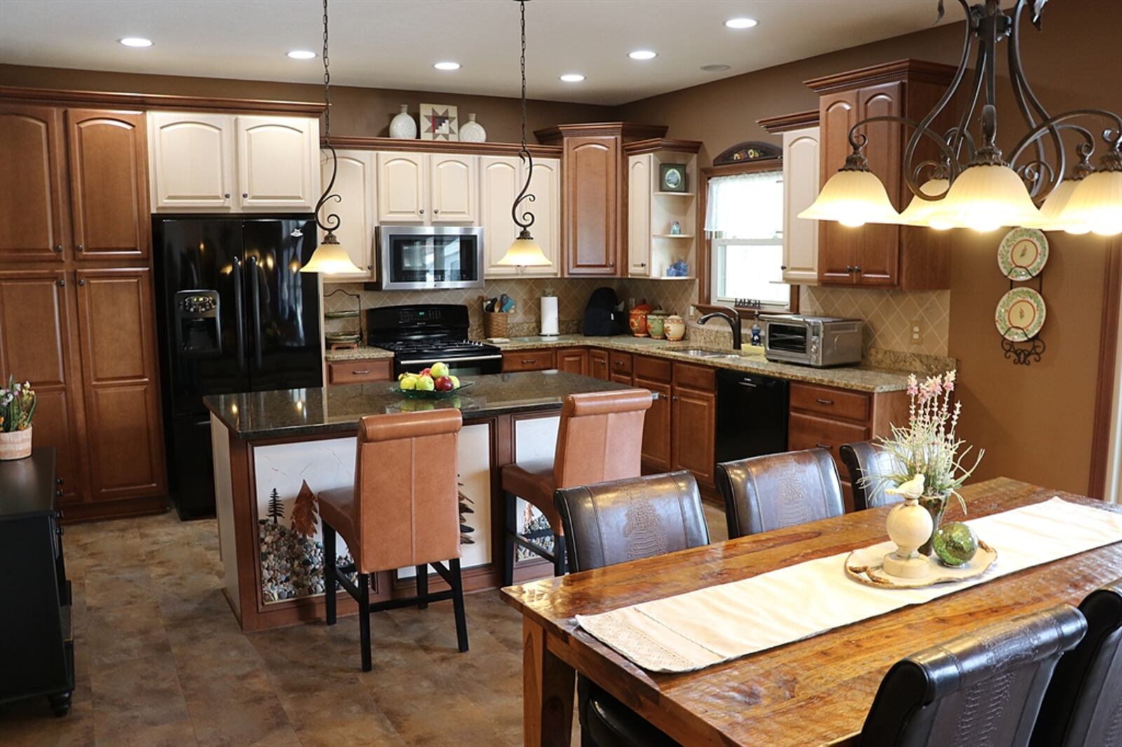 In the kitchen, an island has an extended counter for bar seating.