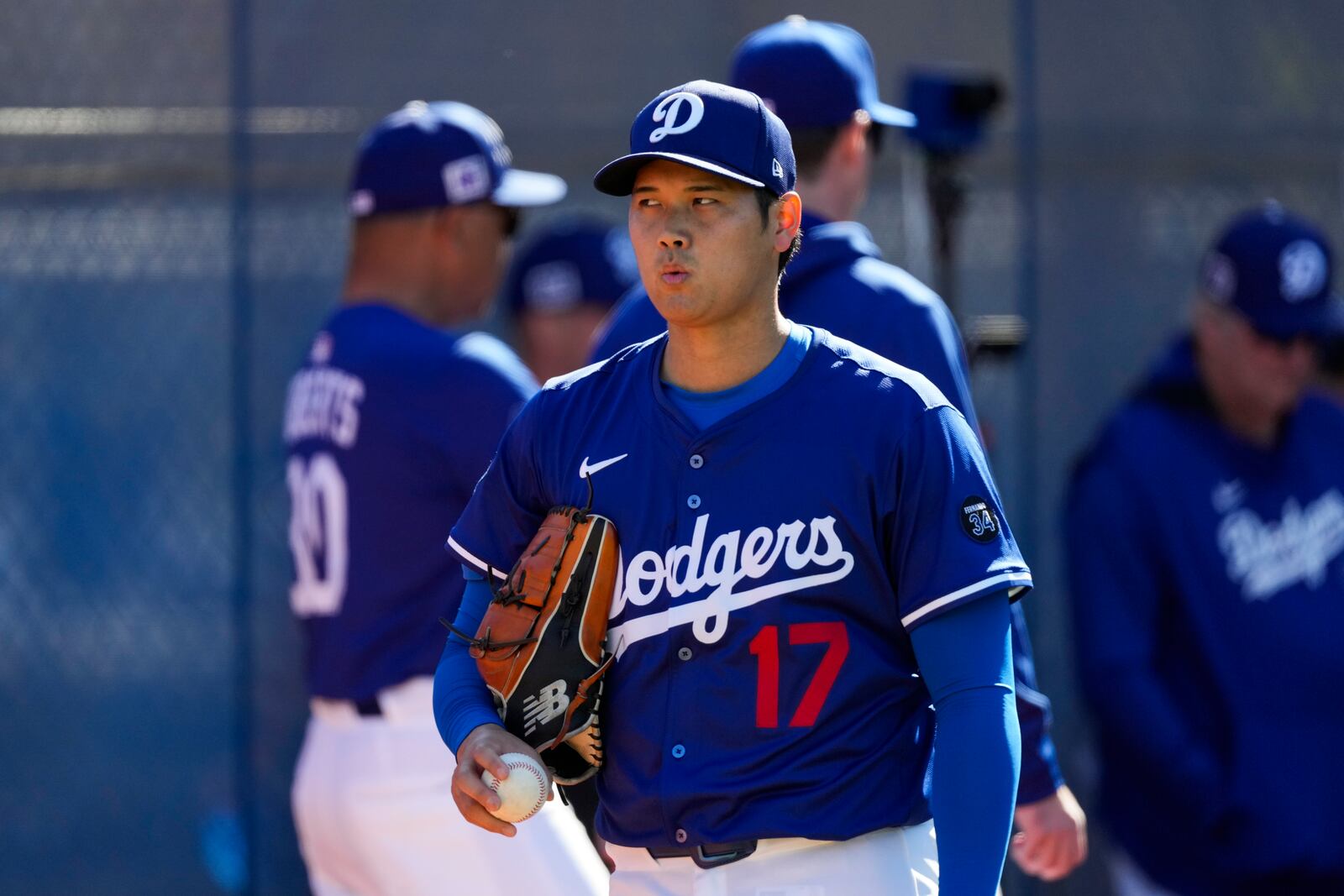 Los Angeles Dodgers two-way player Shohei Ohtani (17) works out during spring training baseball practice, Saturday, Feb. 15, 2025, in Phoenix. (AP Photo/Ashley Landis)