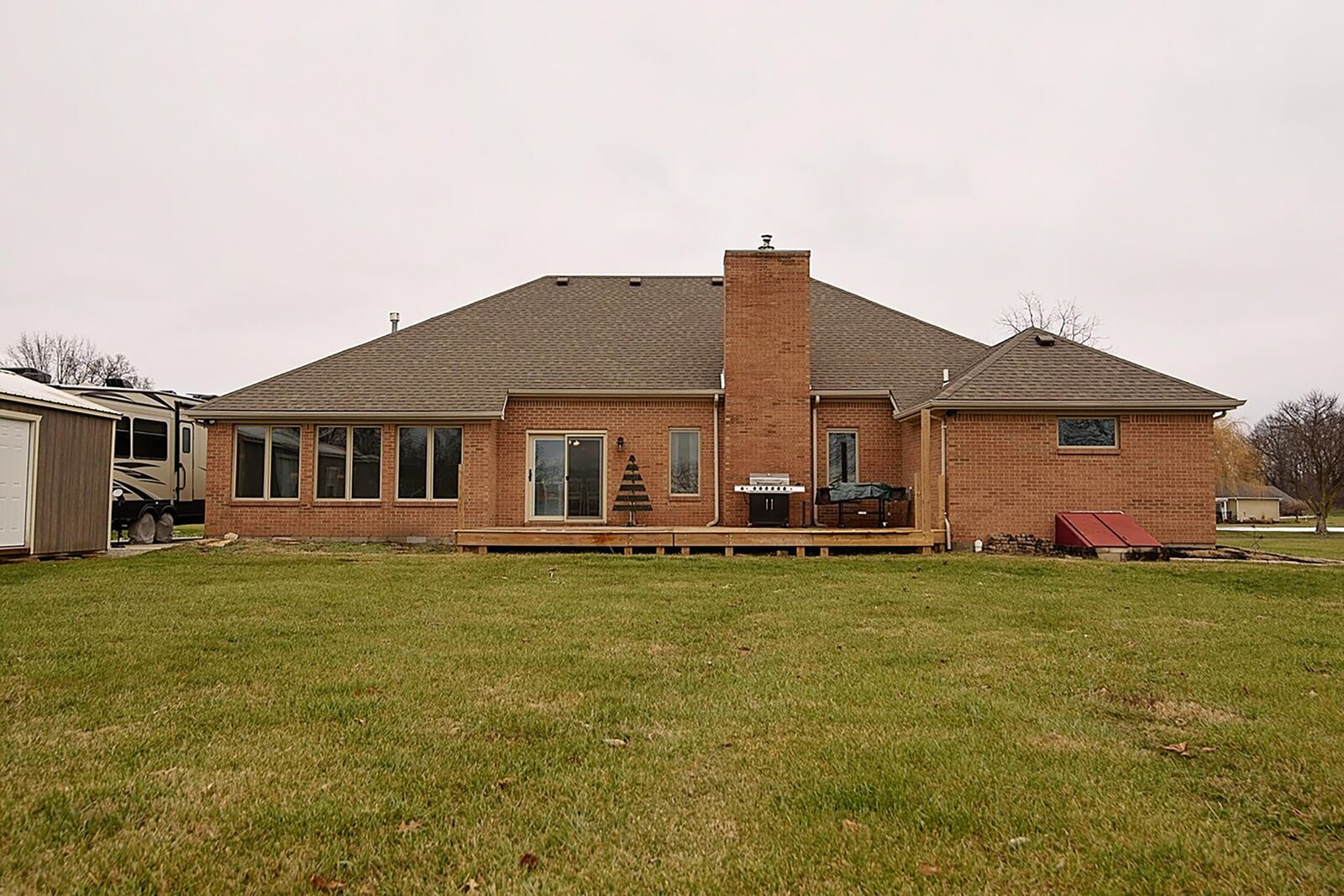 The rear of the home has a wood deck, an oversized outbuilding with additional parking and a brick firepit. CONTRIBUTED