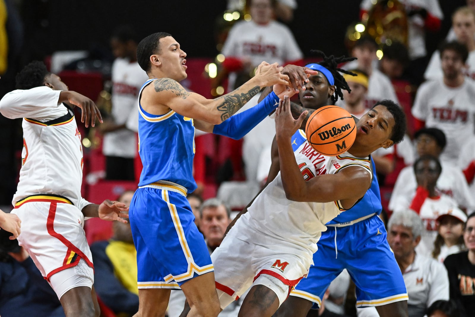 Maryland forward Julian Reese, front right, and UCLA guard Kobe Johnson, second from left, compete for the ball during the second half of an NCAA college basketball game, Friday, Jan. 10, 2025, in College Park, Md. (AP Photo/Terrance Williams)