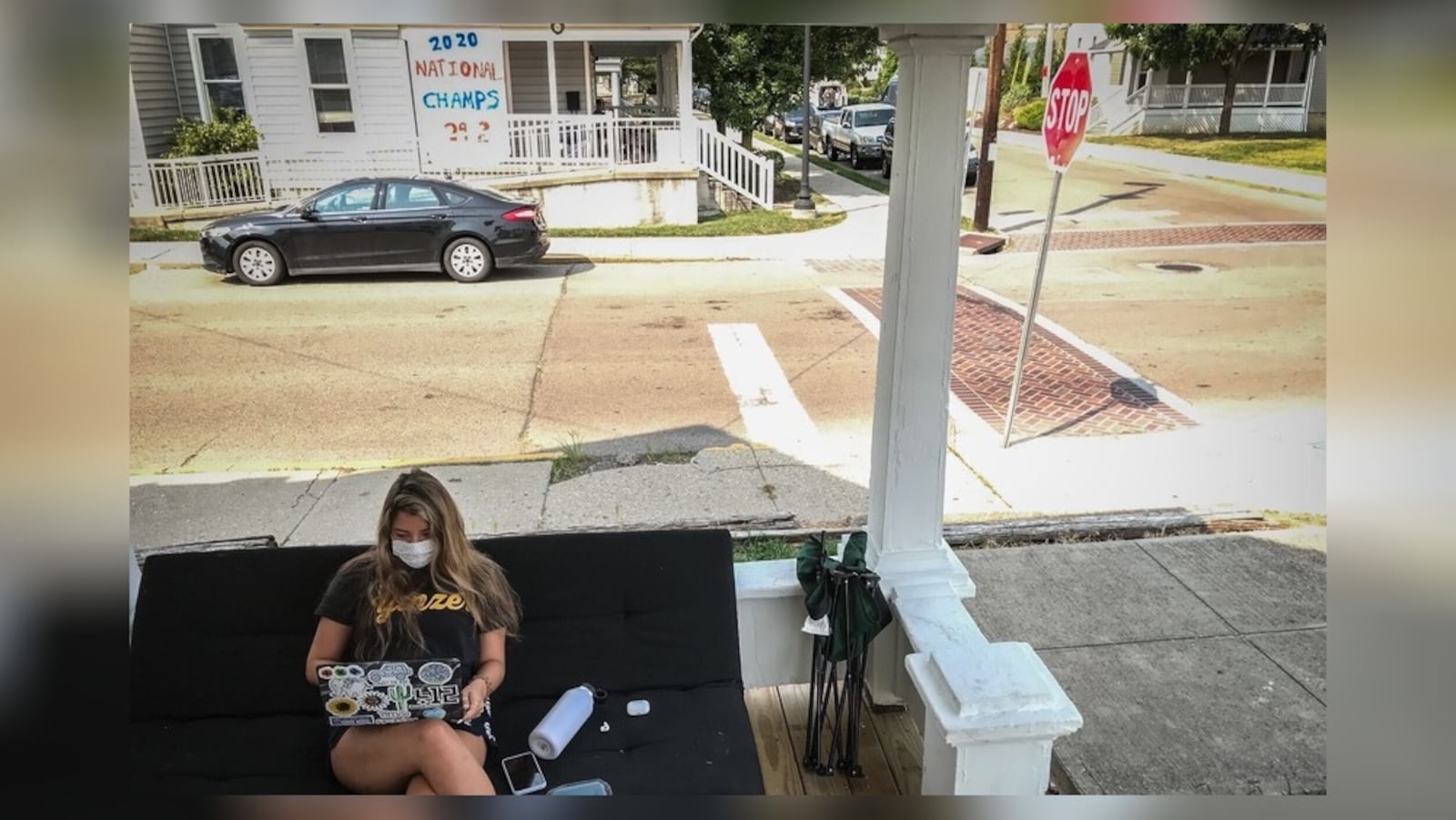 Bree Nurray, a University of Dayton senior from Pittsburgh, takes an online class on the front porch of her rental house on the campus Wednesday Aug. 26, 2020.