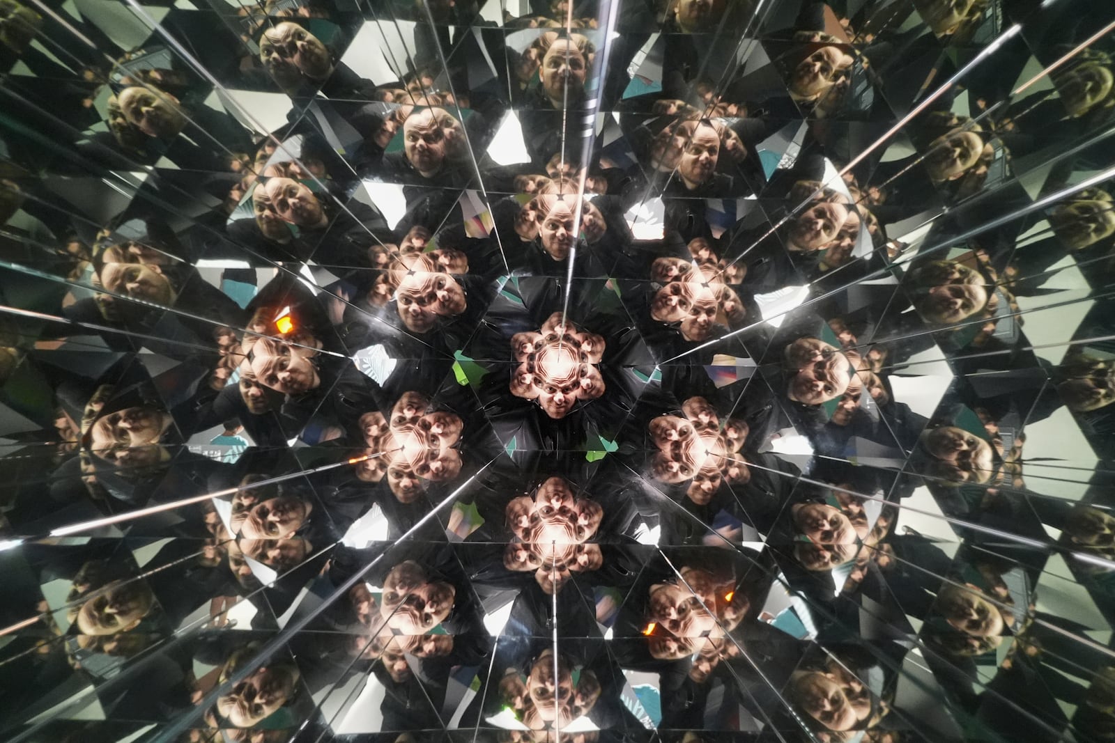 A visitor looks into a kaleidoscope at Paradox Museum Miami, Tuesday, Jan. 28, 2025, in Miami. (AP Photo/Rebecca Blackwell)