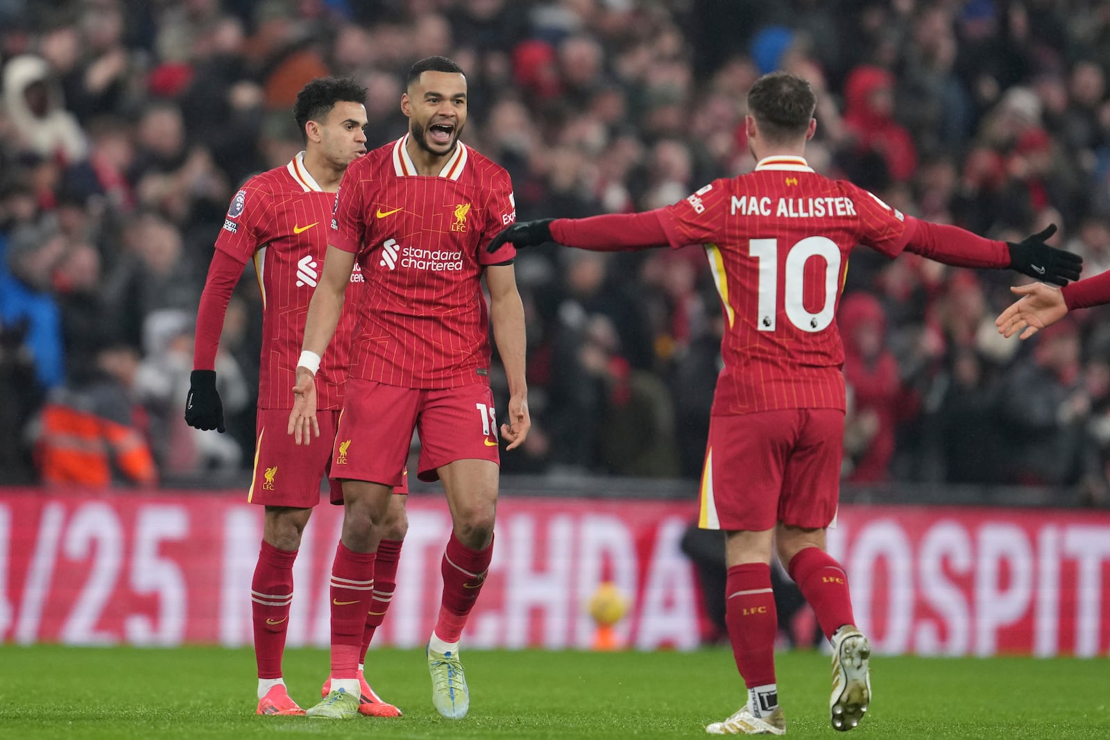 Liverpool's Cody Gakpo, left, celebrates after scoring his side's first goal against Manchester United during the English Premier League soccer match at the Anfield stadium in Liverpool, England, Sunday, Jan. 5, 2025. (AP Photo/Jon Super)