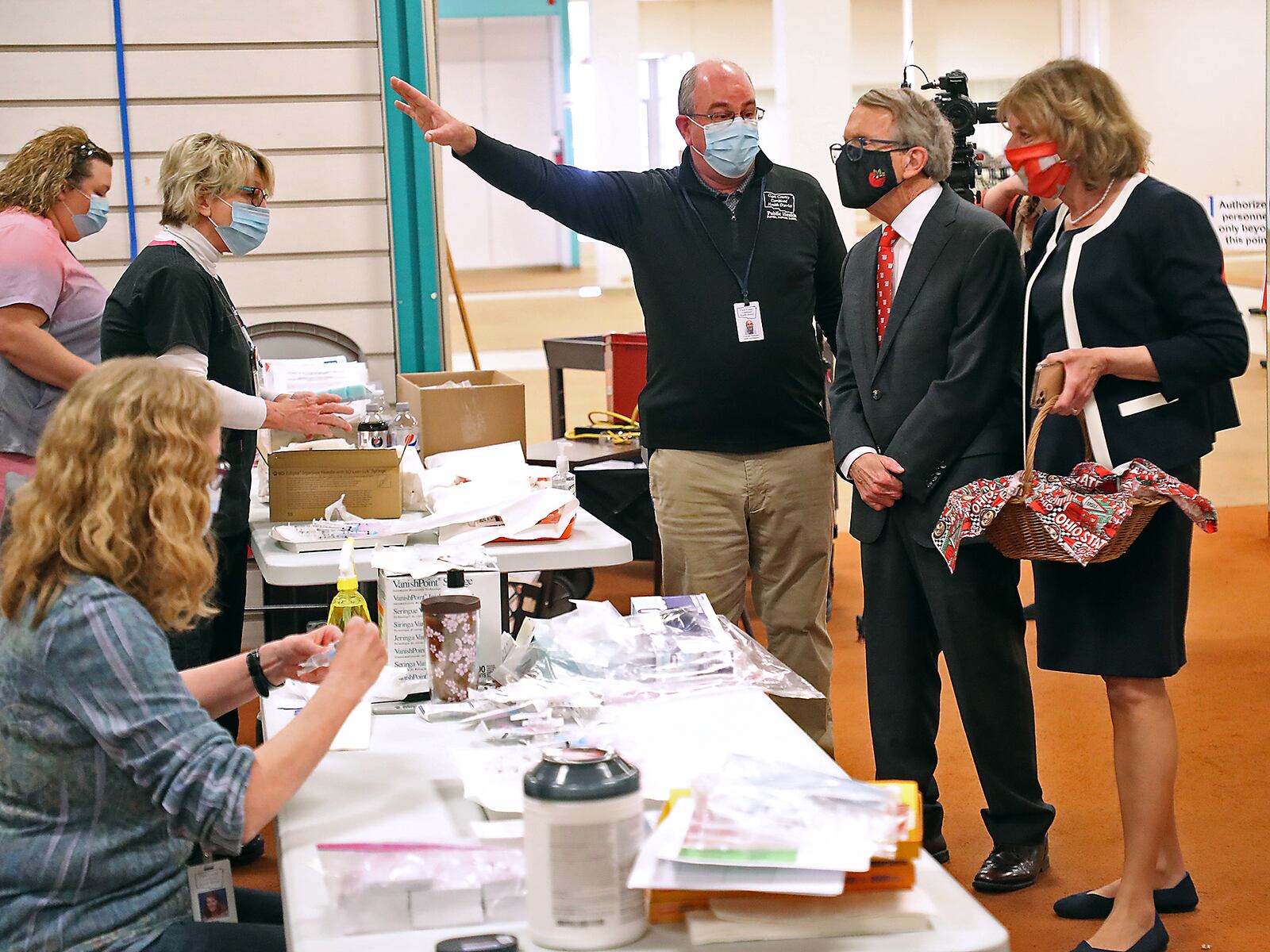 Clark County Health Commissioner Charles Patterson gives Governor Mike DeWine and his wife, Fran, a tour of the Clark County COVID vaccine distribution center at the Upper Valley Mall in March. The clinic is closing on May 27. BILL LACKEY/STAFF