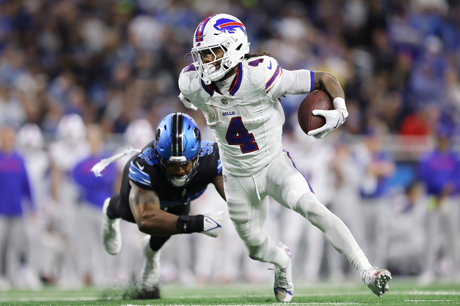 Buffalo Bills running back James Cook (4) runs against Detroit Lions defensive end Za'Darius Smith during the first half of an NFL football game, Sunday, Dec. 15, 2024, in Detroit. (AP Photo/Rey Del Rio)