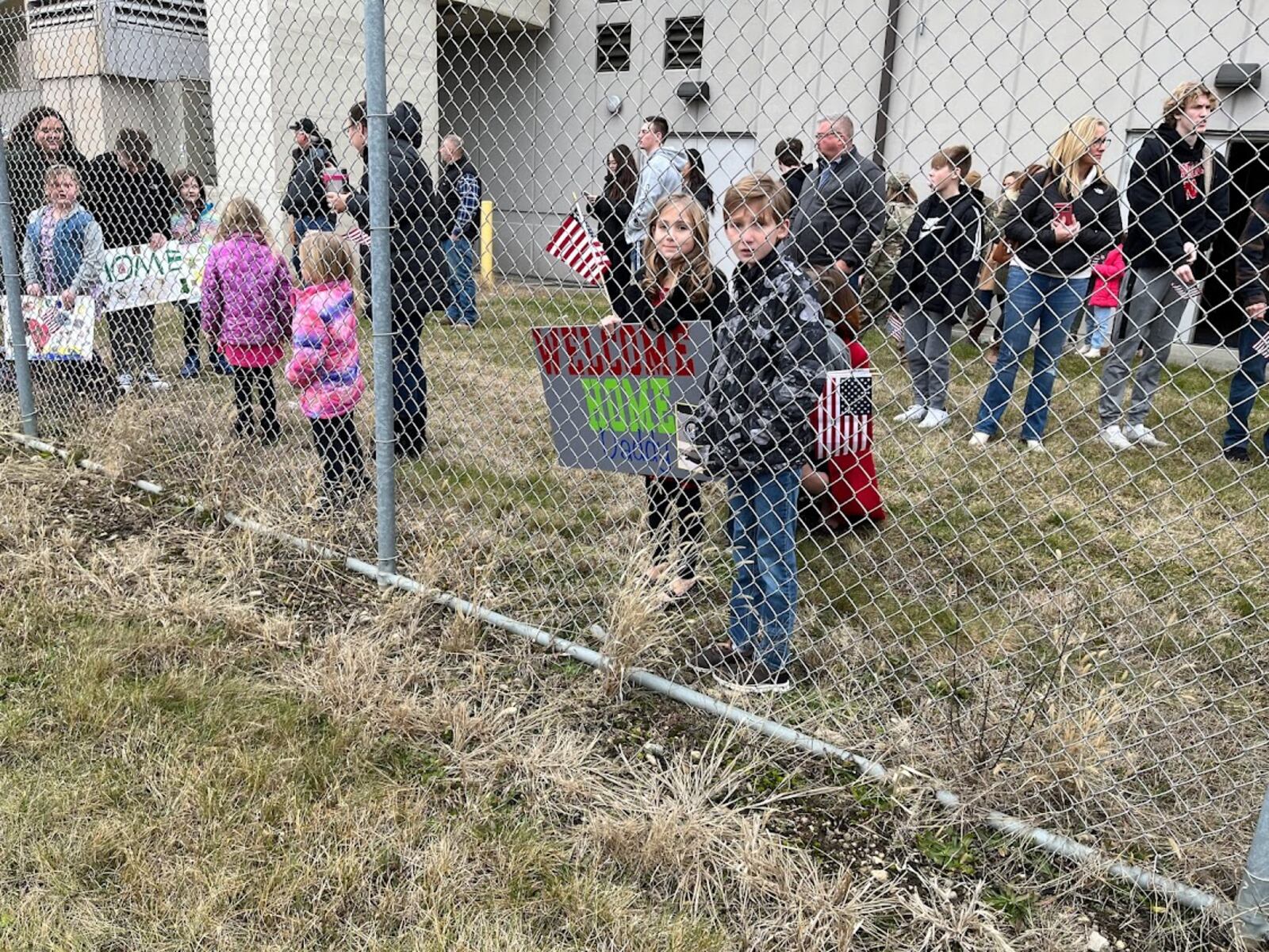 Families ready to greet returning Airmen of the 445th Airlift Wing at Wright-Patterson Air Force Base Thursday. THOMAS GNAU/STAFF