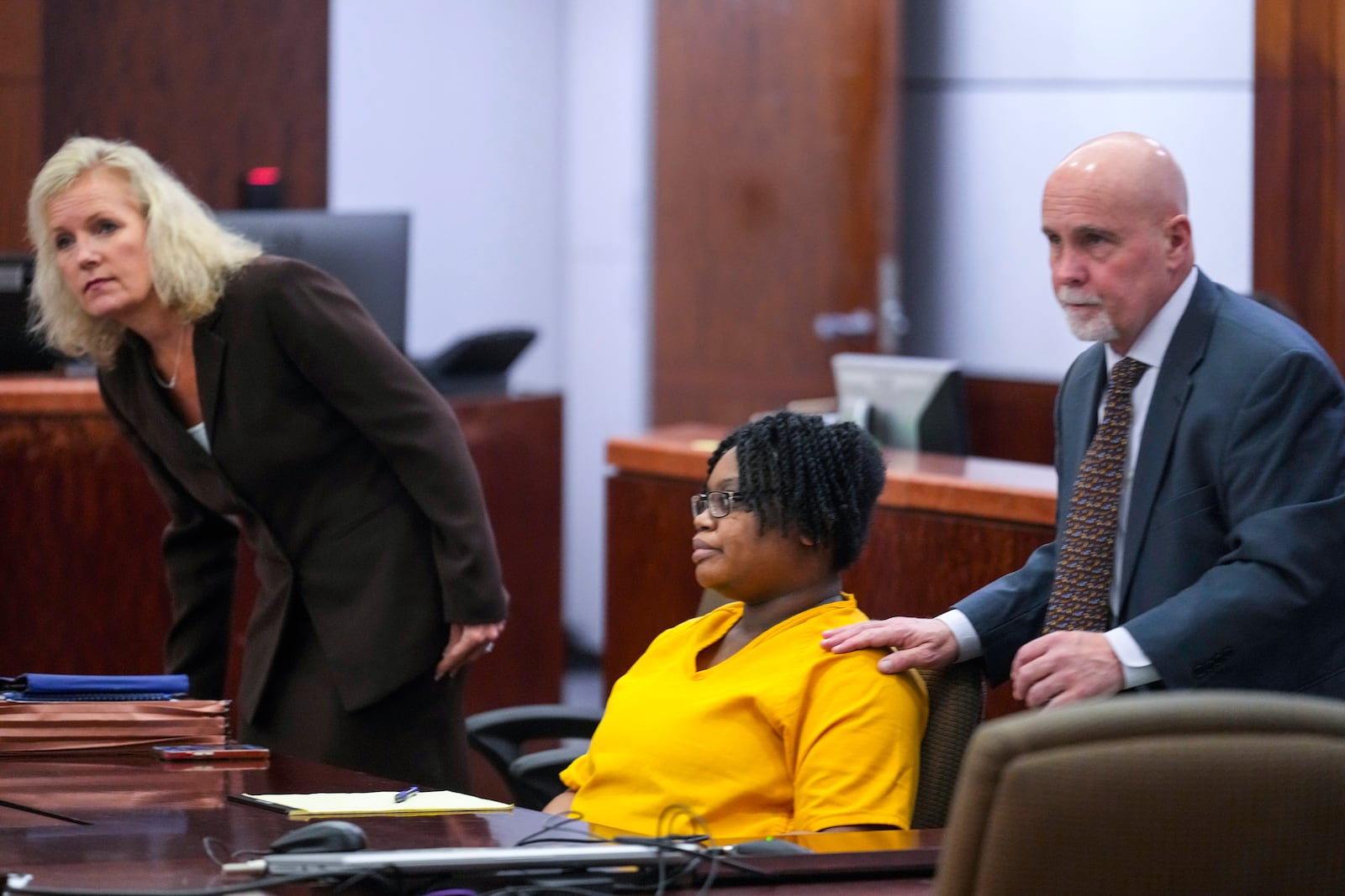 Defendant Gloria Williams, charged in connection with the death of her 8-year-old son, whose skeletal remains decomposed for months inside a Houston-area apartment with three surviving but abandoned siblings, and her lawyers, Beth Exley, left, and Neal Davis III, appear for a hearing, Tuesday, Nov. 12, 2024, at the Harris County Criminal Justice Center in Houston. (Brett Coomer/Houston Chronicle via AP)