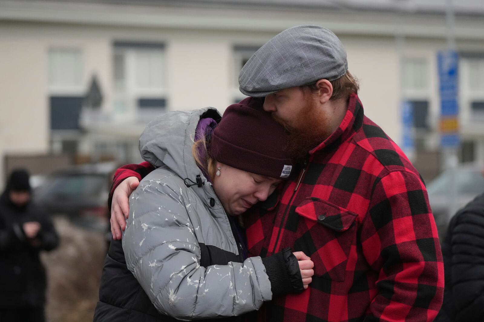 People gather at a makeshift memorial near the scene of a shooting on the outskirts of Orebro, Sweden, Wednesday, Feb. 5, 2025. (AP Photo/Sergei Grits)