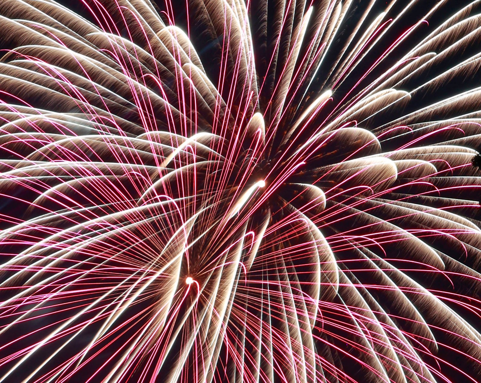 The rain stopped just in time for the Buck Creek Boom fireworks show to go on Monday, July 3, 2023 in Springfield. Spectators lined the shore of Buck Creek to watch the annual show put on by the National Trail Parks and Recreation District. BILL LACKEY/STAFF