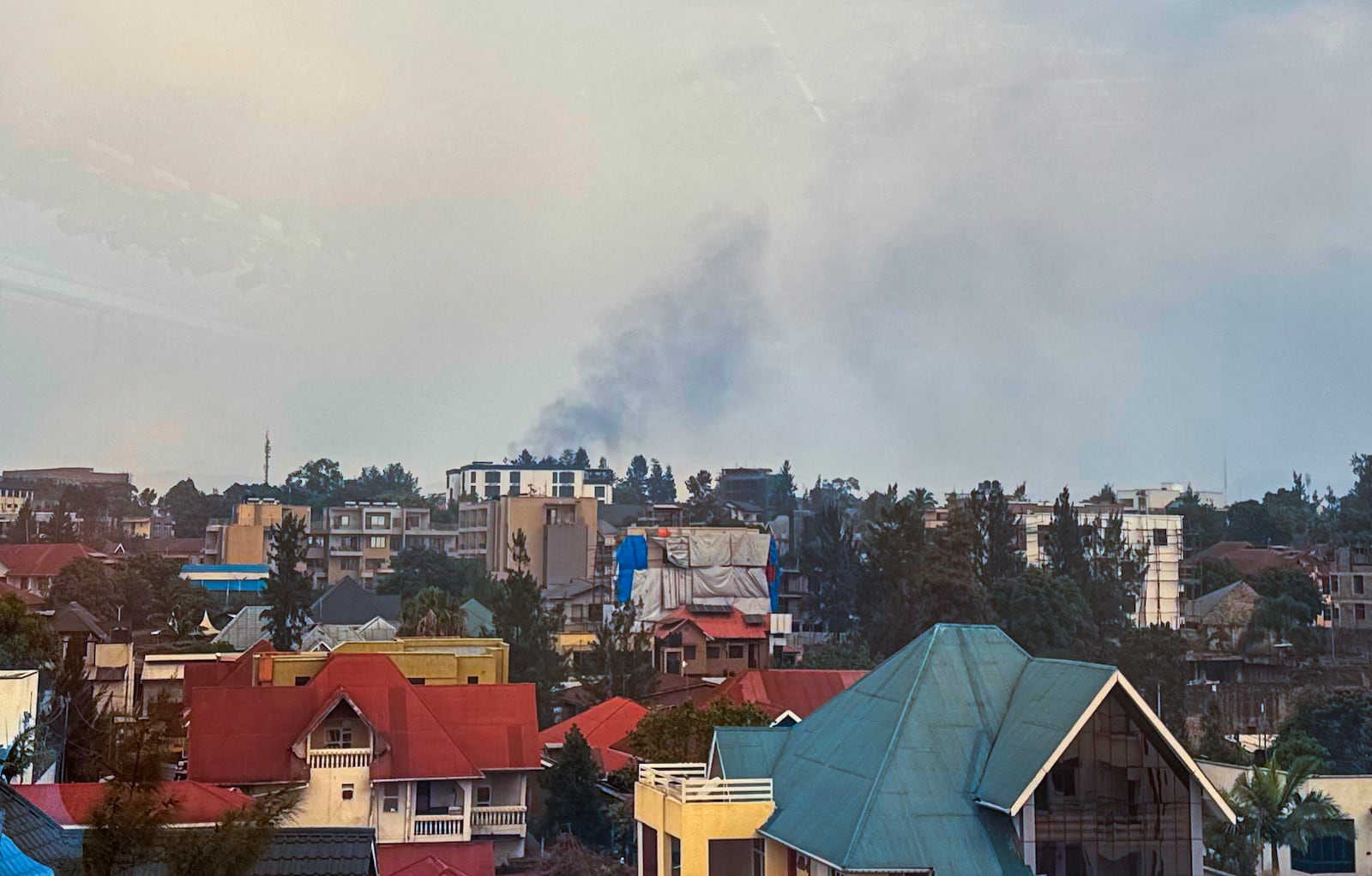 Smoke rises over Goma, Democratic Republic of the Congo, Monday, Jan. 27, 2025, as M23 rebels make their way to the center of the town. (AP Photo/Moses Sawasawa)