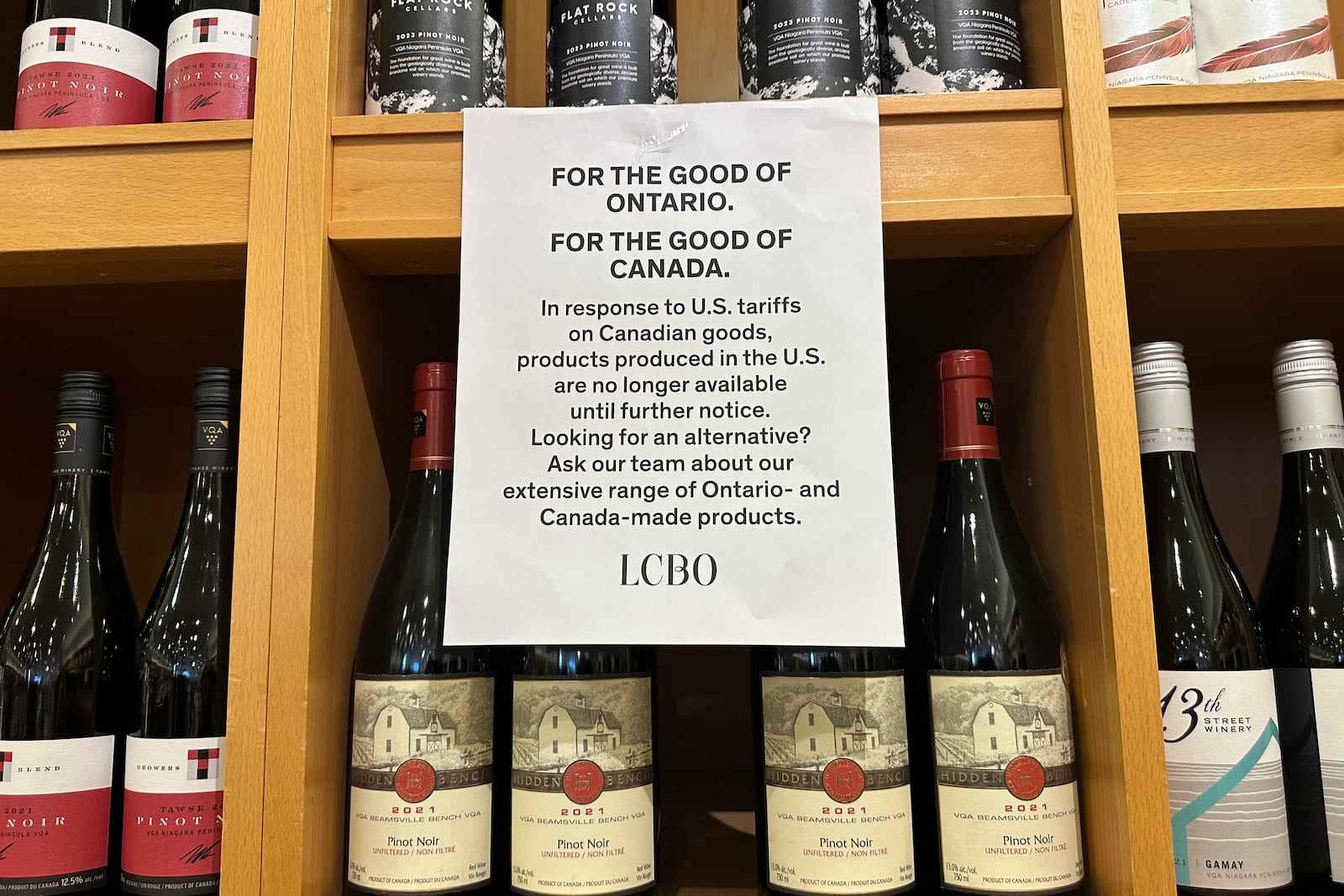 A sign is posted on a wine shelves at an LCBO, the government-run liquor stores where most wine and spirits in the province are purchased, Sunday, March 9, 2025, in Toronto. (AP Photo/Jill Colvin)