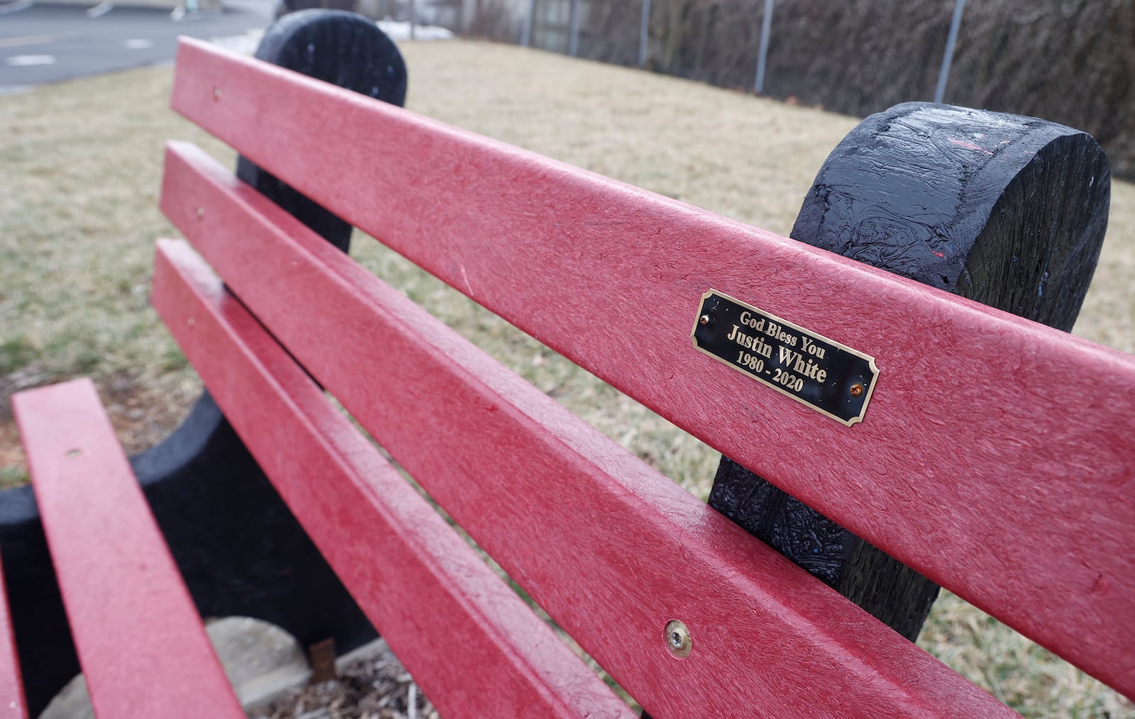 A plastic memorial bench remembering Justin White at St. Teresa Catholic Church Feb. 10, 2023. BILL LACKEY/STAFF