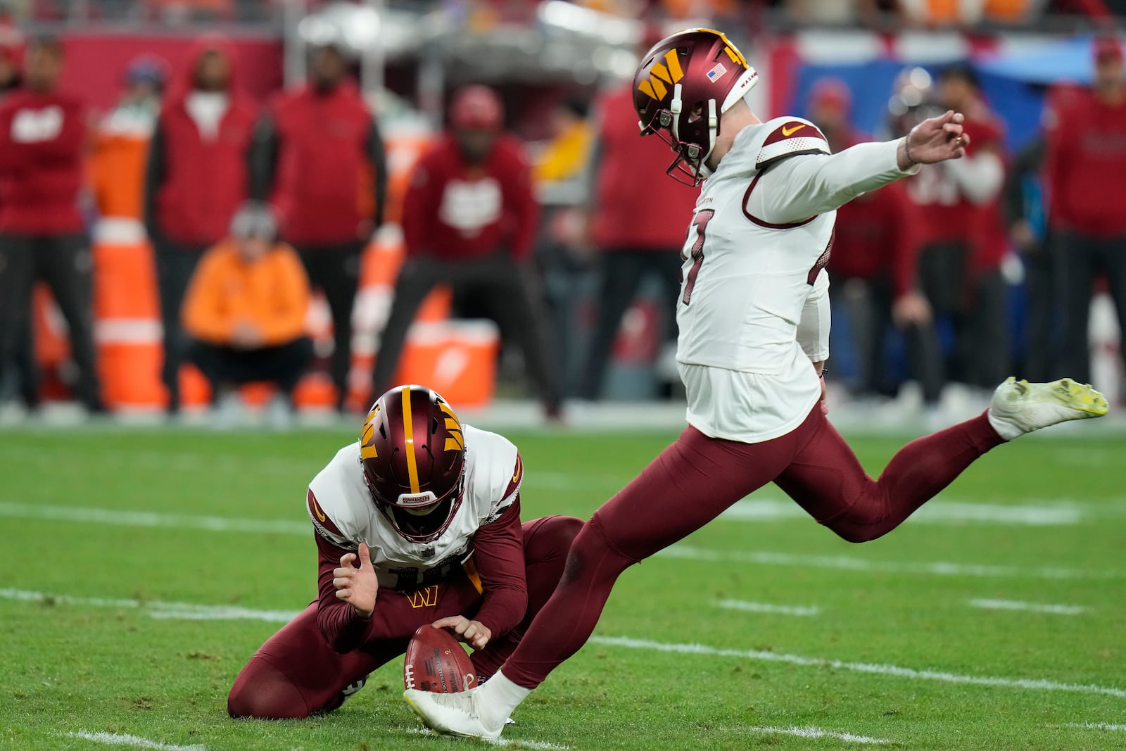 FILE - Washington Commanders place kicker Zane Gonzalez, right, kicks the game winning field goal from the hold of Tress Way during the second half of an NFL wild-card playoff football game against the Tampa Bay Buccaneers in Tampa, Fla., Jan. 12, 2025. (AP Photo/Chris O'Meara, File)