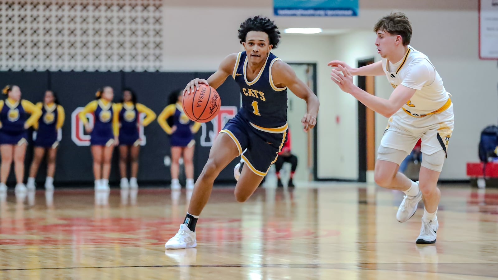 Springfield High School sophomore CJ Wallace drives past Centerville sophomore Sam Keely during a Division I district semifinal game on Tuesday, Feb. 26, at Trotwood Madison High School. MICHAEL COOPER/STAFF PHOTO