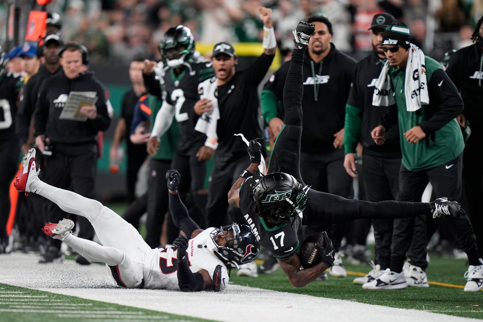 Houston Texans safety Eric Murray (23) tackles New York Jets wide receiver Davante Adams (17) during the second half of an NFL football game Thursday, Oct. 31, 2024, in East Rutherford, N.J. (AP Photo/Frank Franklin II)