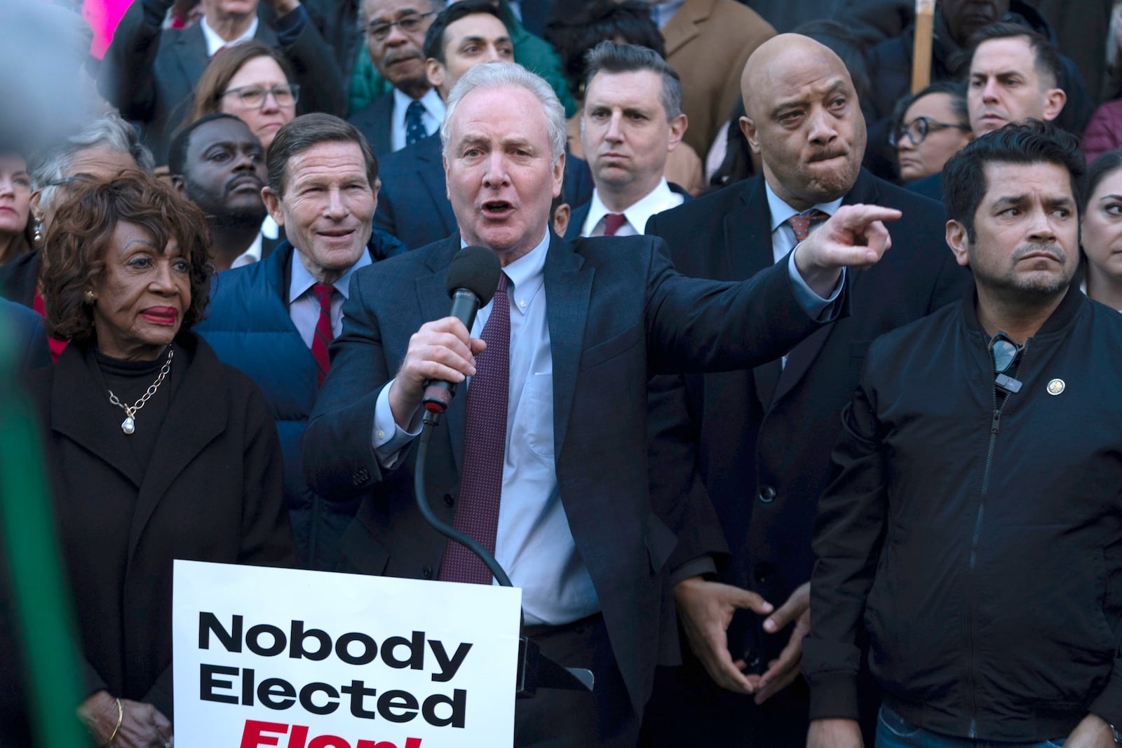 Sen. Chris Van Hollen, D-Md., accompanied by other members of congress, speaks during a rally against Elon Musk outside the Treasury Department in Washington, Tuesday, Jan. 30, 2025. (AP Photo/Jose Luis Magana)