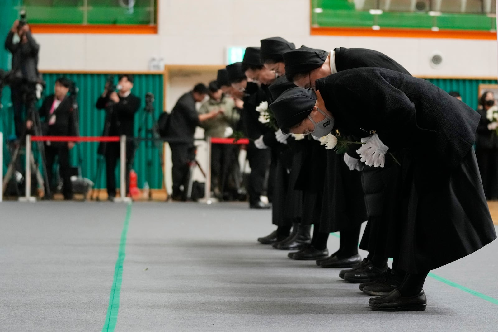 Nuns bow for the victims of a plane fire at a memorial altar at Muan sport park in Muan, South Korea, Monday, Dec. 30, 2024. (AP Photo/Ahn Young-joon)