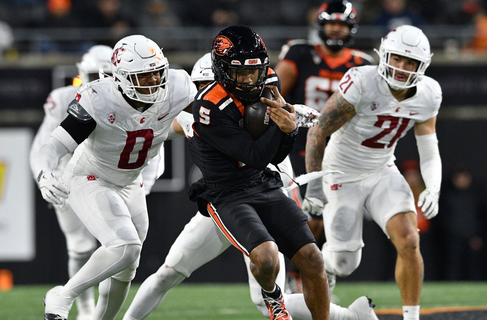 Washington State linebacker Taariq Al-Uqdah (0) pursues Oregon State quarterback Gabarri Johnson (5) during the first half of an NCAA college football game Saturday, Nov. 23, 2024, in Corvallis, Ore. (AP Photo/Mark Ylen)