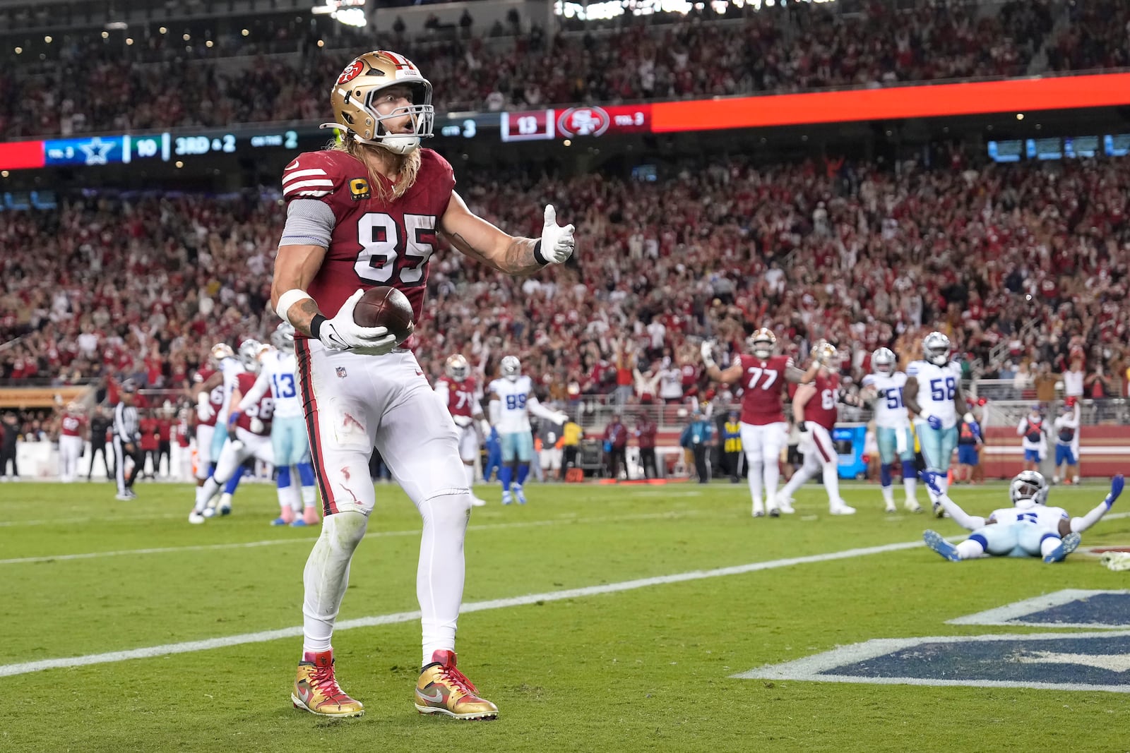 San Francisco 49ers tight end George Kittle (85) reacts after catching a touchdown pass against the Dallas Cowboys during the second half of an NFL football game in Santa Clara, Calif., Sunday, Oct. 27, 2024. (AP Photo/Tony Avelar)