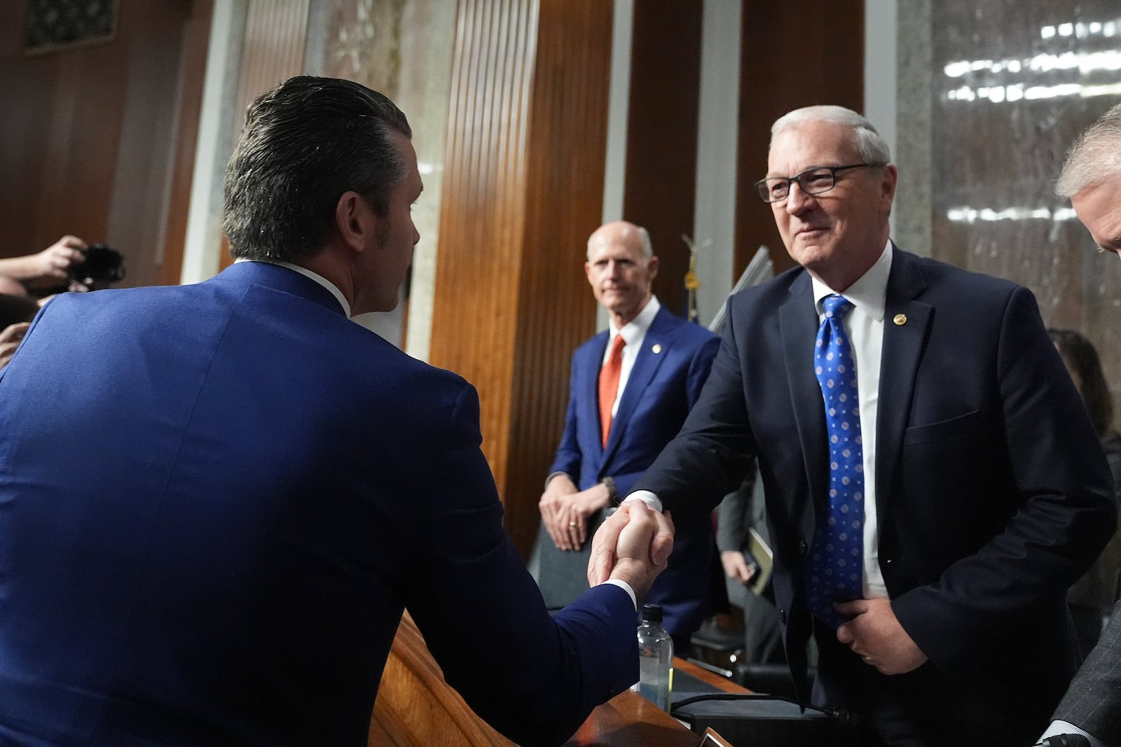 Pete Hegseth, left, President-elect Donald Trump's choice to be Defense secretary, shakes hands with Sen. Kevin Cramer, R-N.D., right, after appearing before the Senate Armed Services Committee for his confirmation hearing, at the Capitol in Washington, Tuesday, Jan. 14, 2025. (AP Photo/Jacquelyn Martin)