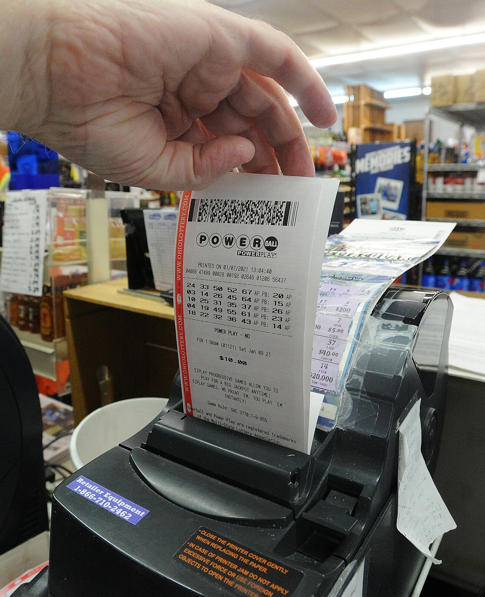 Lots of people buying Mega Millions tickets at Bee-Gee's Mini Market in Kettering, Thursday, Jan. 7, 2021. MARSHALL GORBY\STAFF