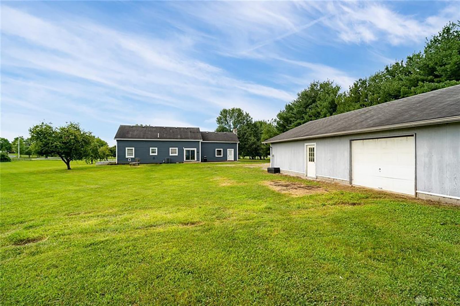 In back, a concrete patio opens from the eat-in kitchen. A pole barn on the property includes a separate apartment. The property also has 2 attached loafing sheds and a fenced garden area. CONTRIBUTED PHOTO