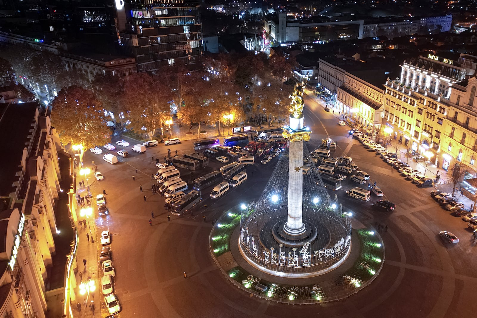 Police vehicles and ambulances are parked outside the parliament's building where people gathered to protest the government's decision to suspend negotiations on joining the European Union for four years in Tbilisi, Georgia, on Friday, Nov. 29, 2024. (AP Photo/Zurab Tsertsvadze)