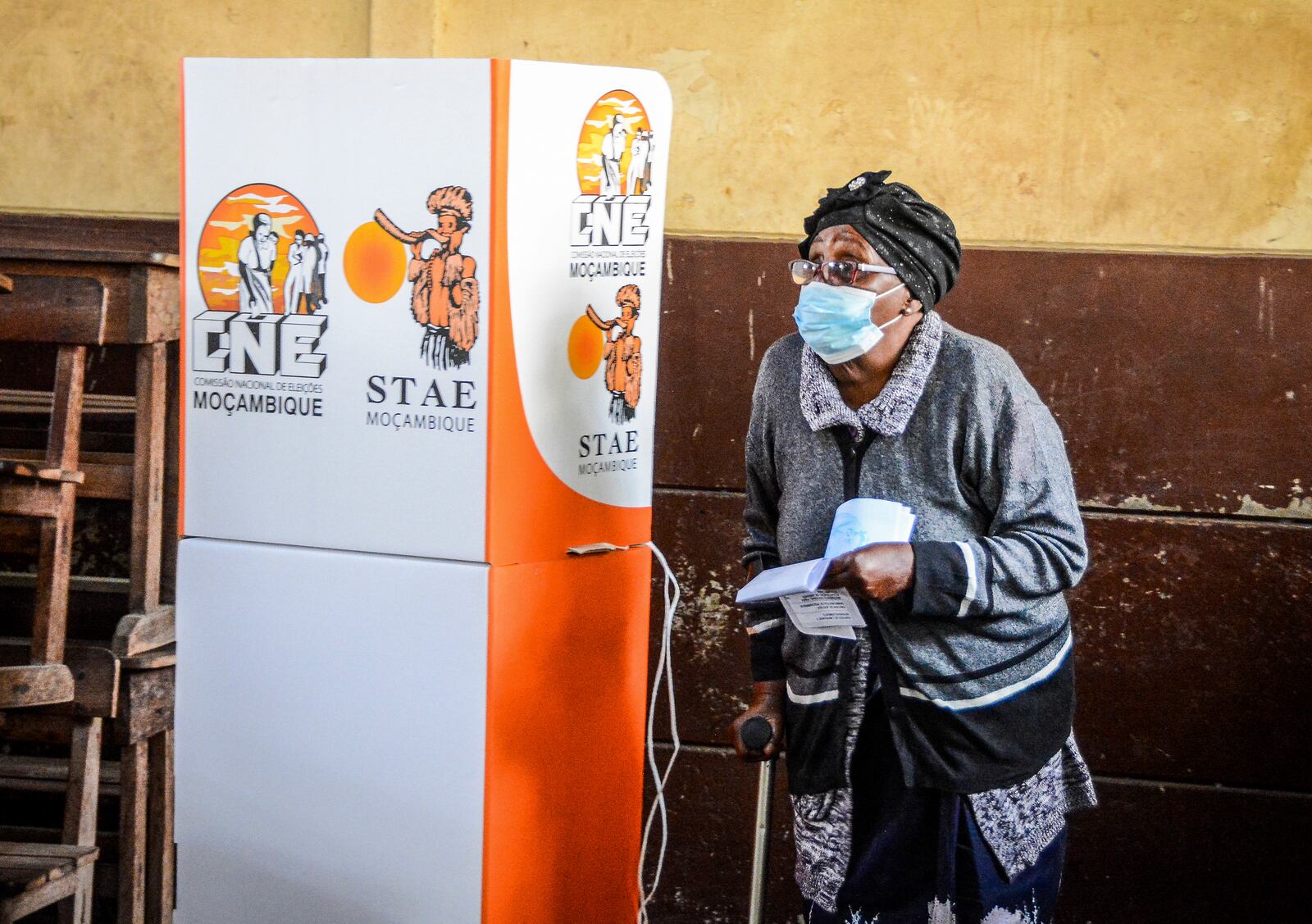 A woman walks out of a polling booth to cast her vote in general elections in Maputo, Mozambique, Wednesday, Oct. 9, 2024. (AP Photo/Carlos Equeio)